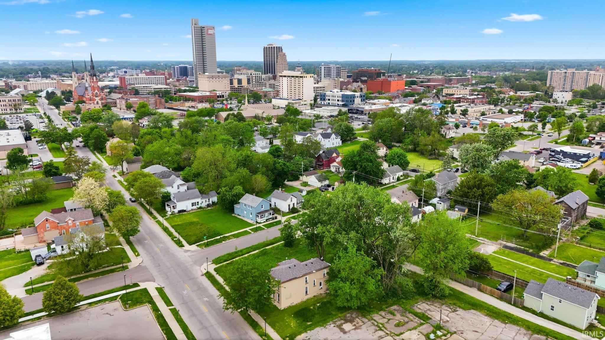 Aerial perspective showcasing an urban landscape with a mix of residential properties and downtown buildings