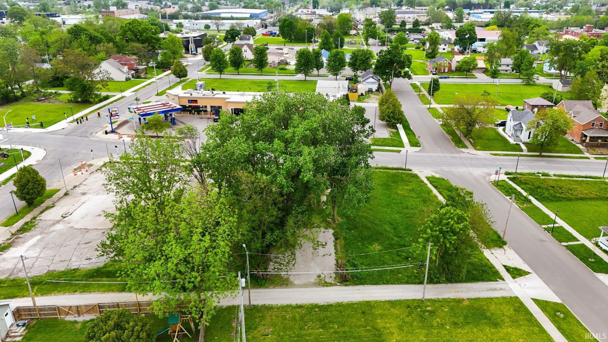 Expansive corner lot featuring mature trees and green space