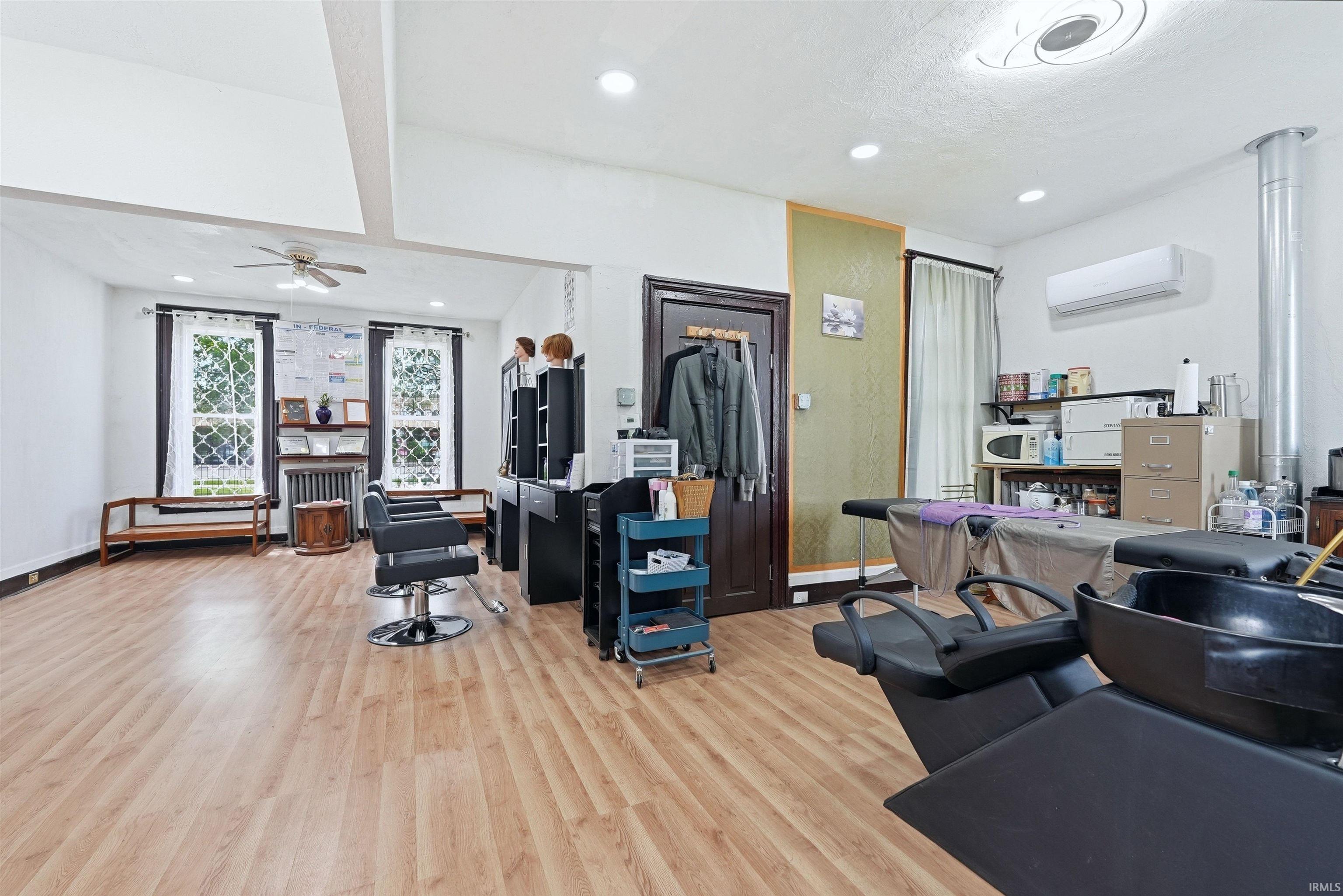 Spacious interior with wood-finish flooring, recessed lighting, and a ceiling fan