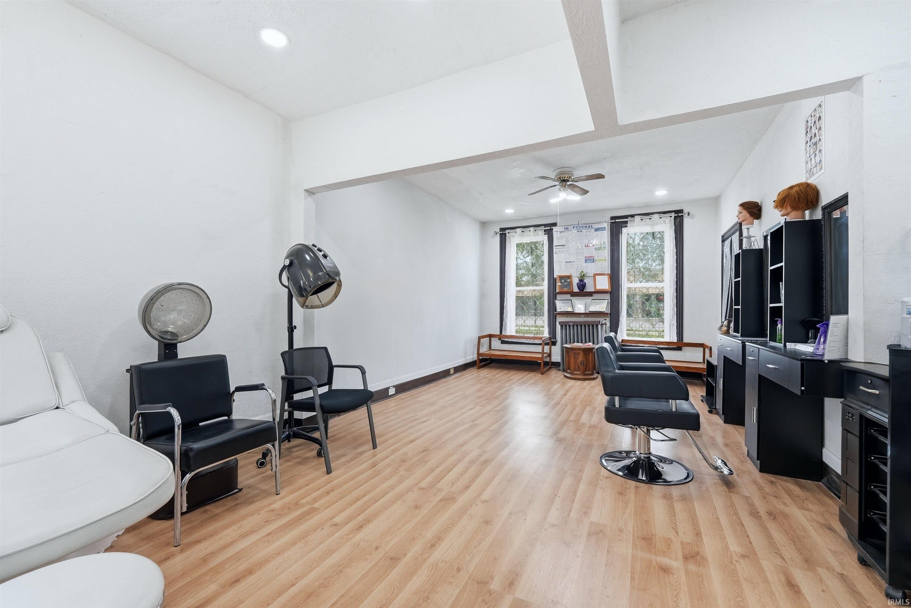 Spacious ground level featuring wood-finish flooring and ample natural light from multiple windows