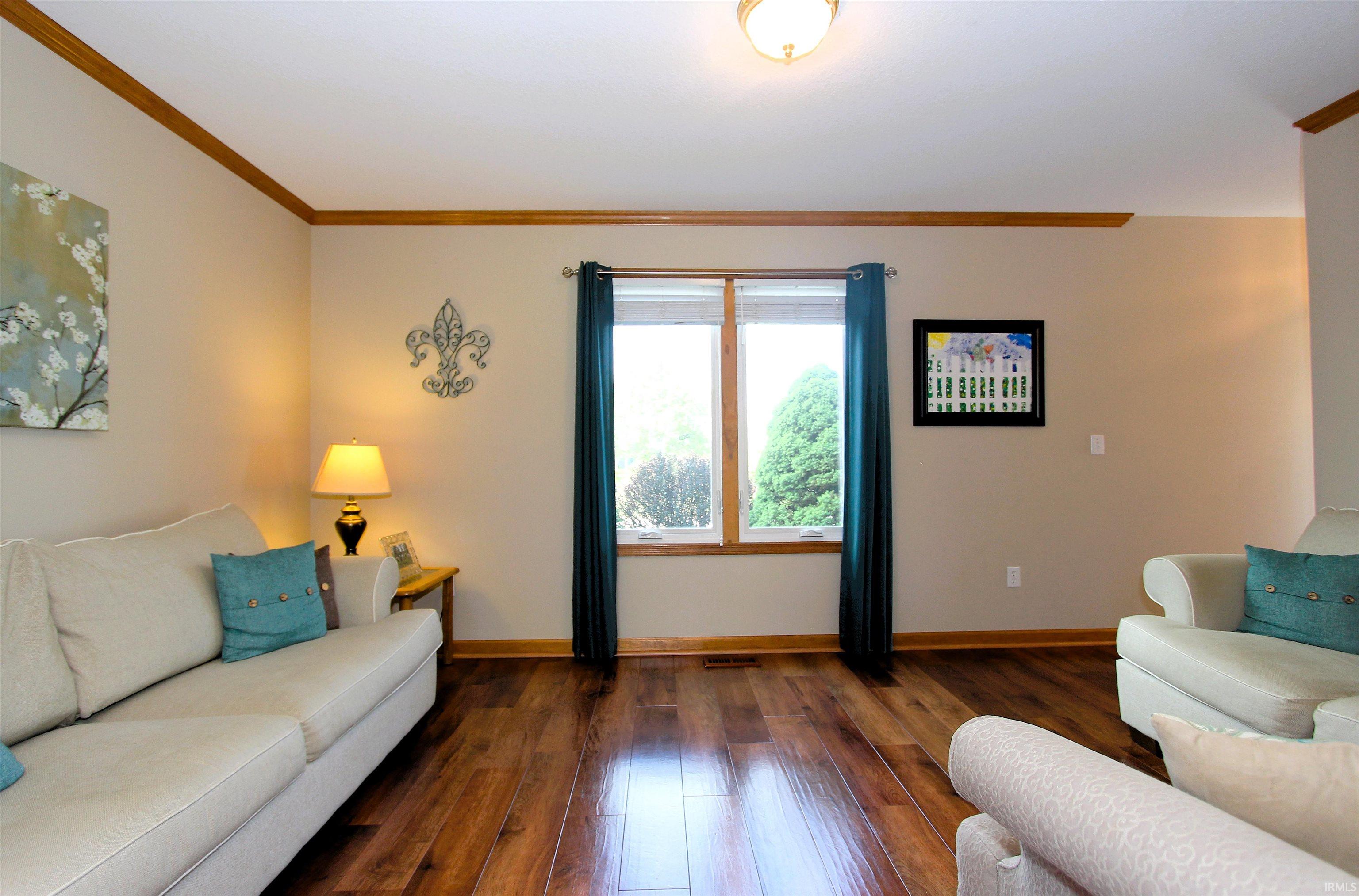 Hardwood-style flooring throughout a room featuring natural light from a double window