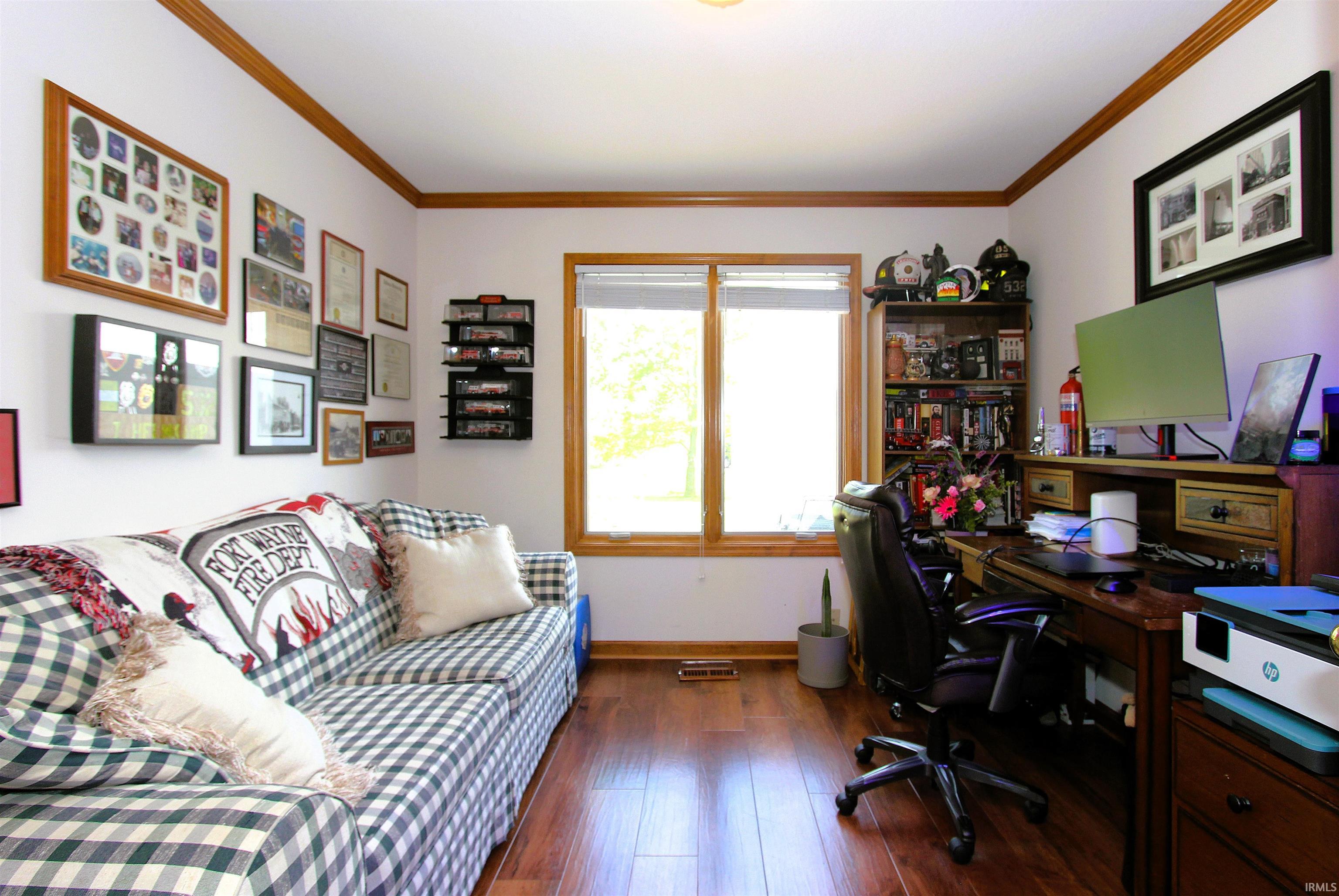 Bright room featuring wood-finish flooring and extensive natural light from a double window
