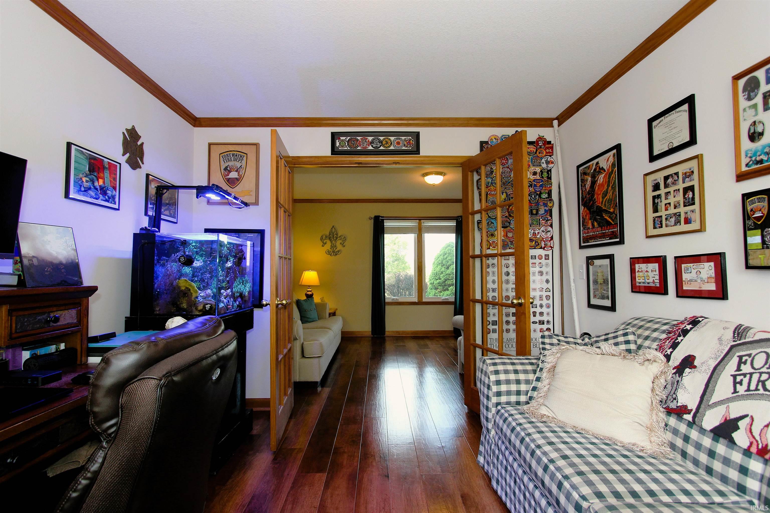 Rich wood-finish flooring throughout, complemented by wood trim and crown molding
