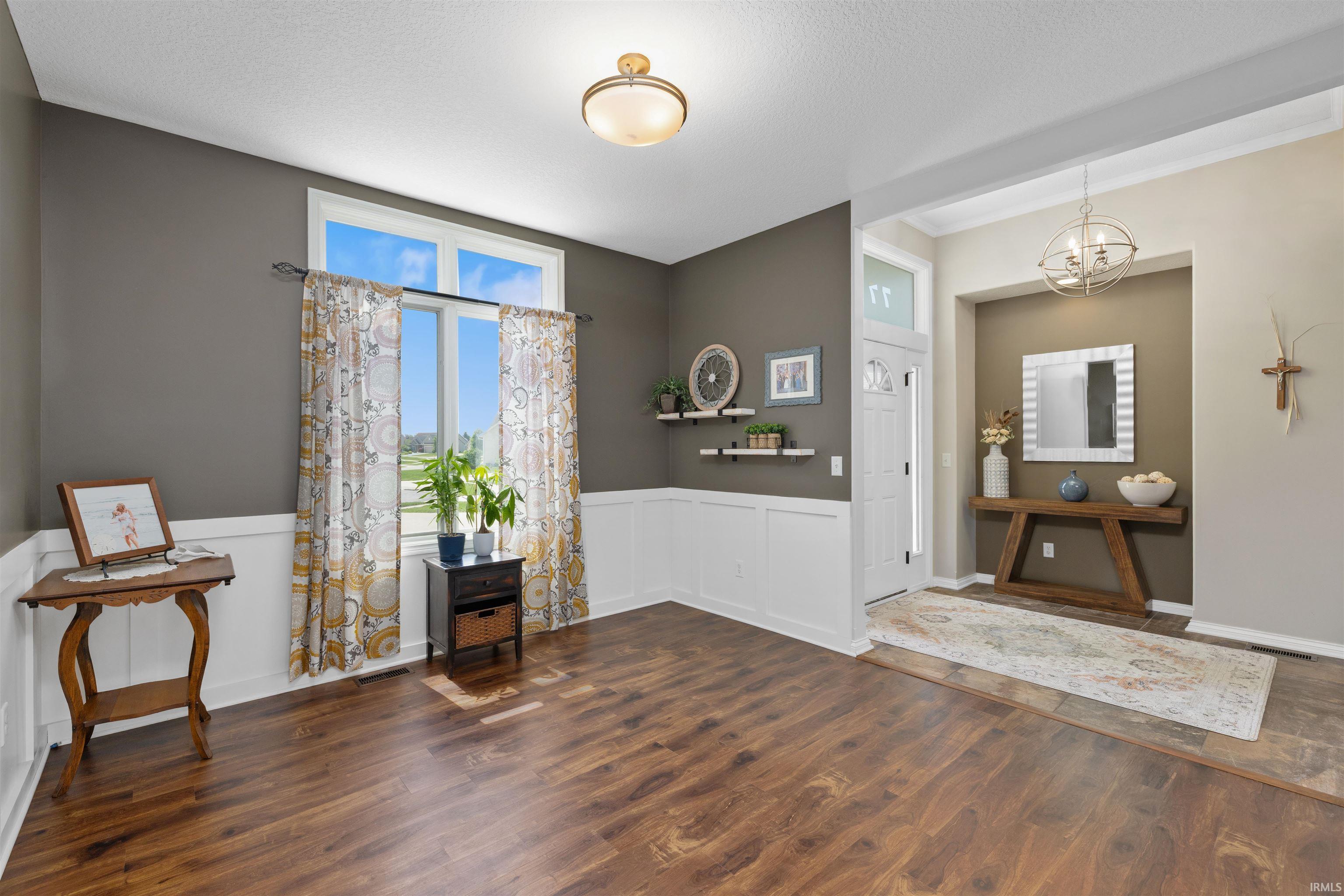 Wood-finish flooring throughout, complemented by crisp white wainscoting and trim