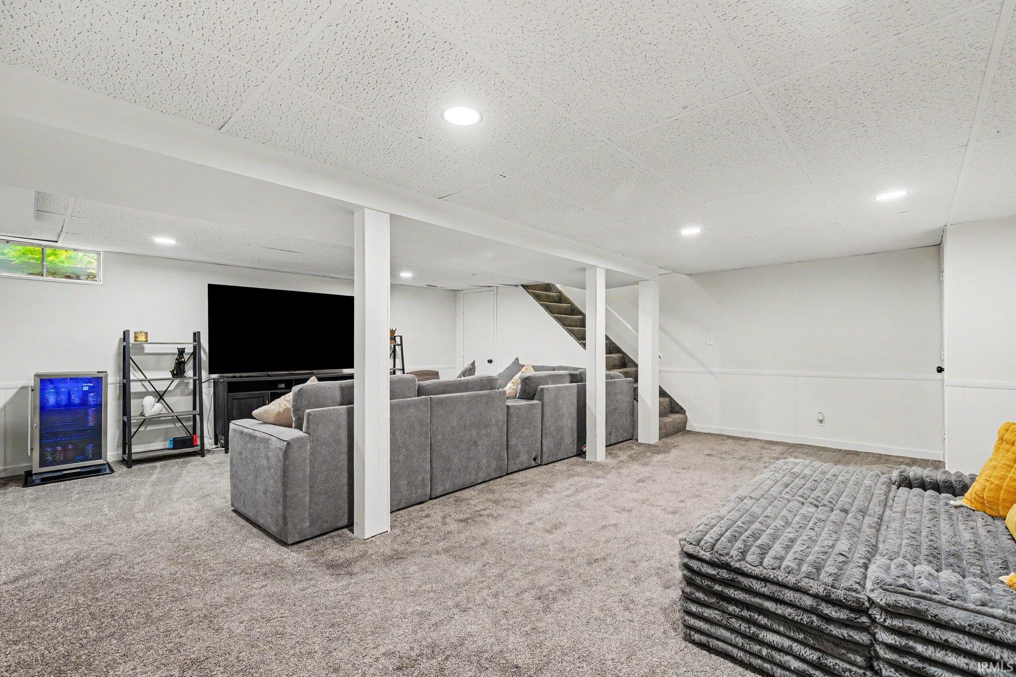 Lower level room featuring recessed lighting and gray carpet flooring