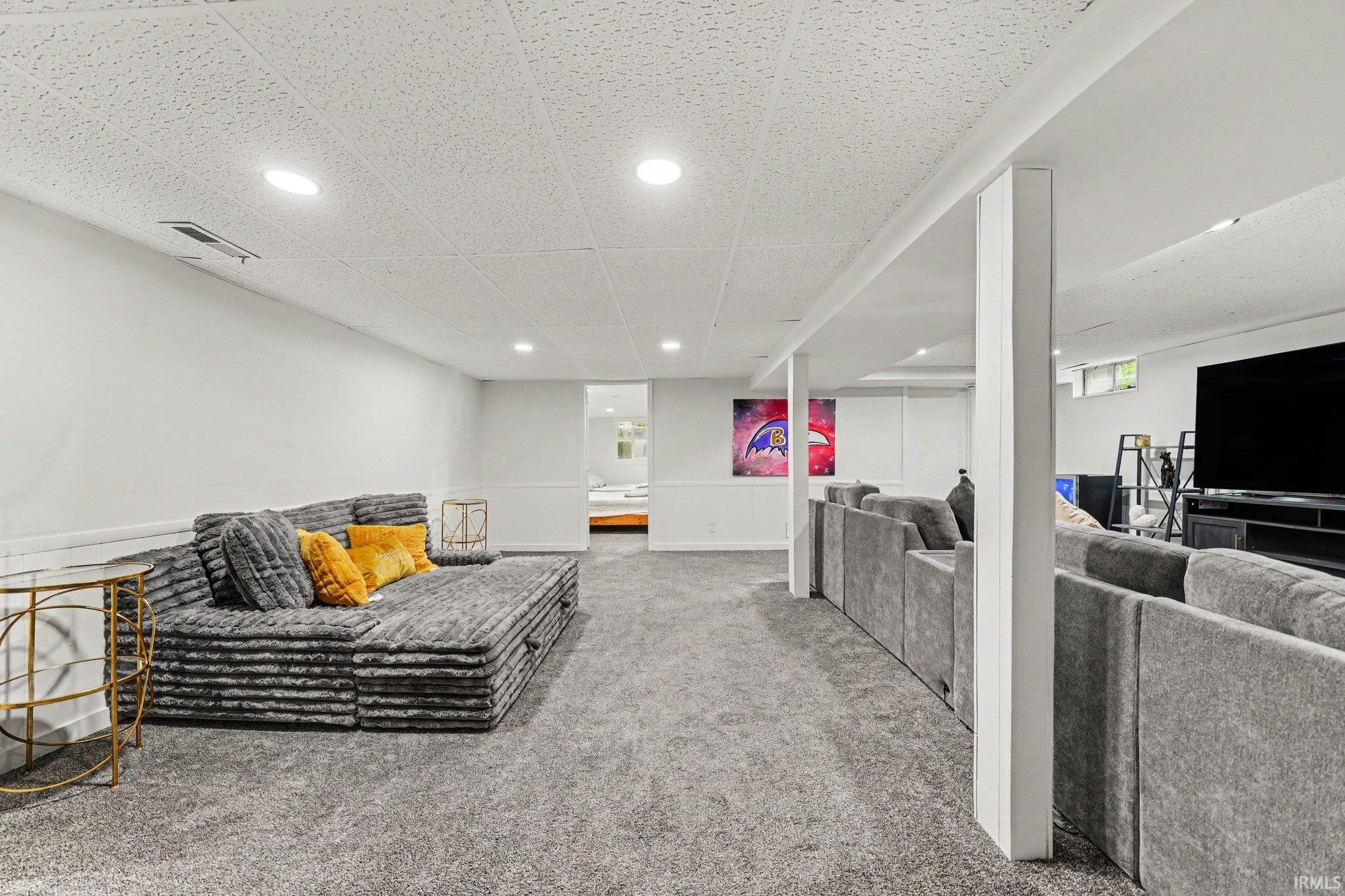 Spacious lower level featuring recessed lighting, a drop ceiling, and plush gray carpeting