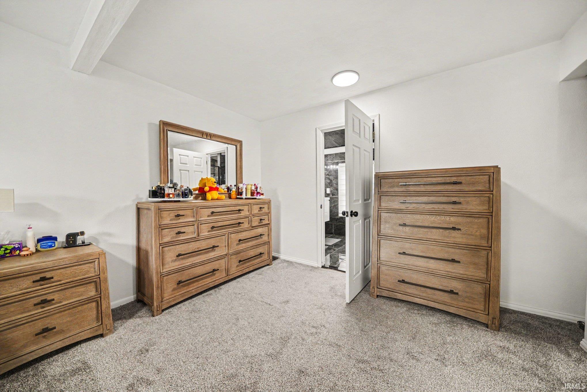 White walls with a light-colored ceiling beam