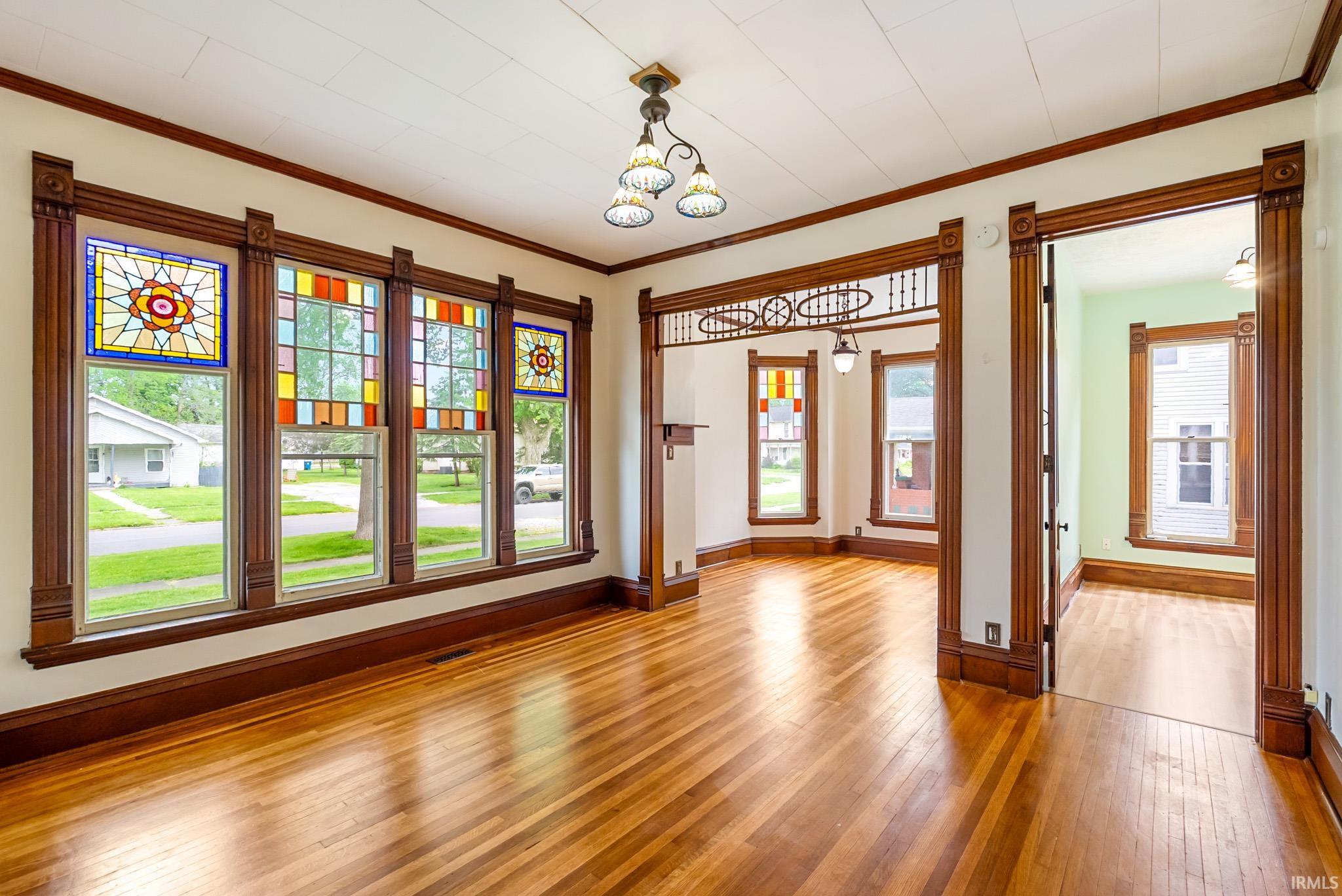 Hardwood flooring throughout featuring stained glass window accents