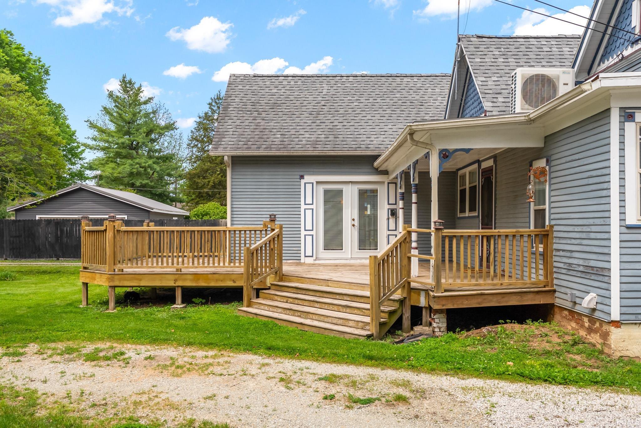 Expansive wooden deck with railing and multi-level stairs
