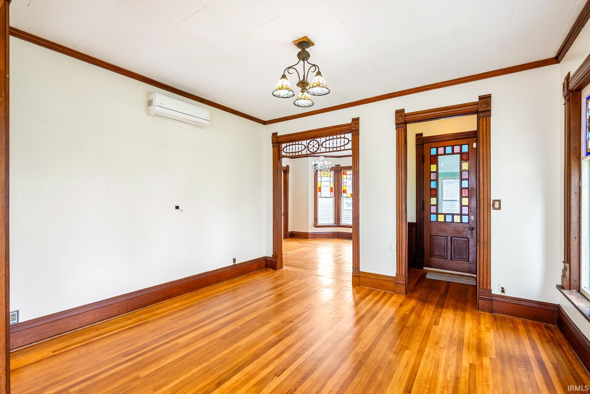 Hardwood flooring complements rich wood trim throughout