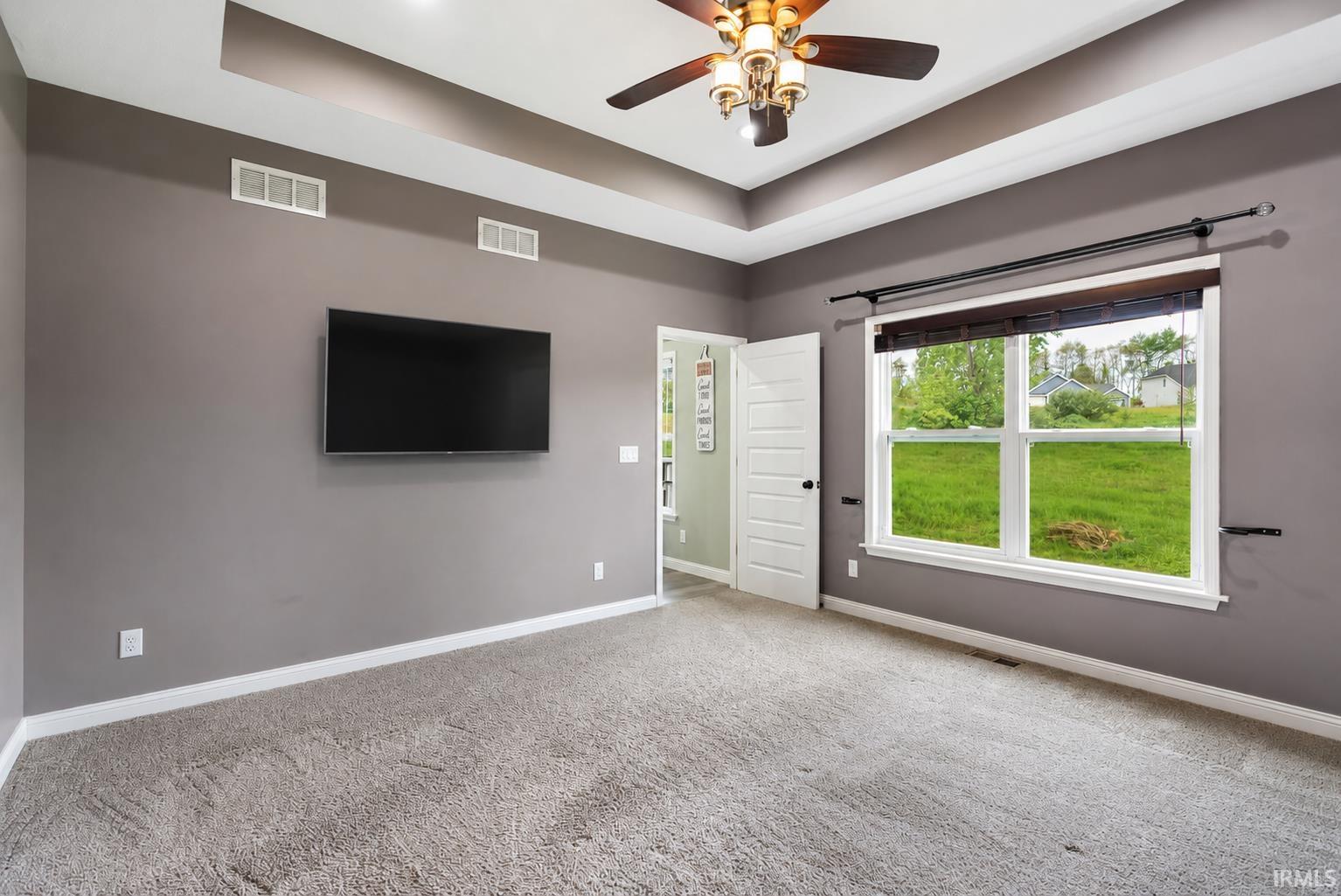 Tray ceiling with recessed lighting and a ceiling fan