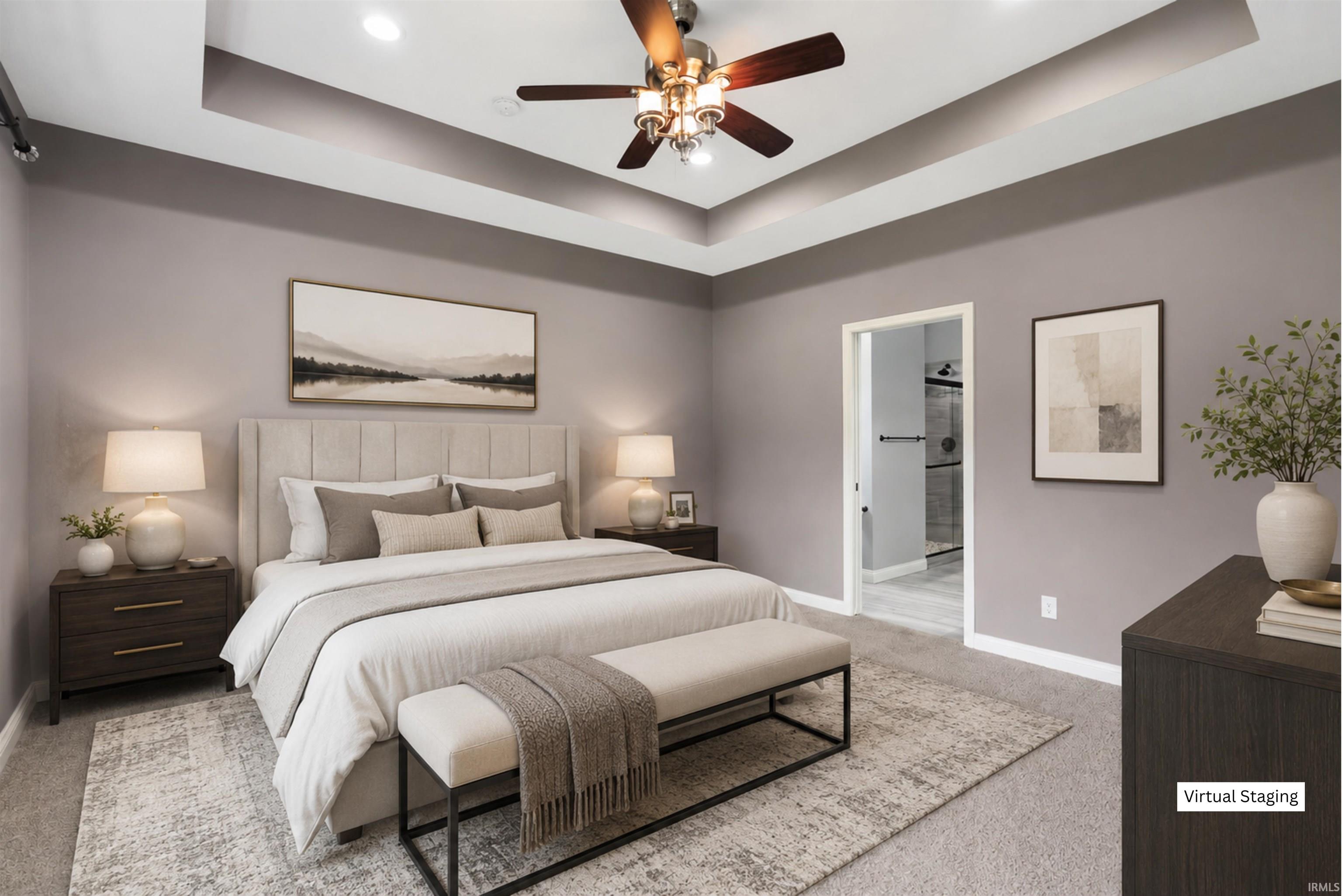 Bedroom featuring a tray ceiling with recessed lighting and a ceiling fan, plush carpet flooring, and an open doorway revealing an ensuite bathroom with a glass-enclosed shower