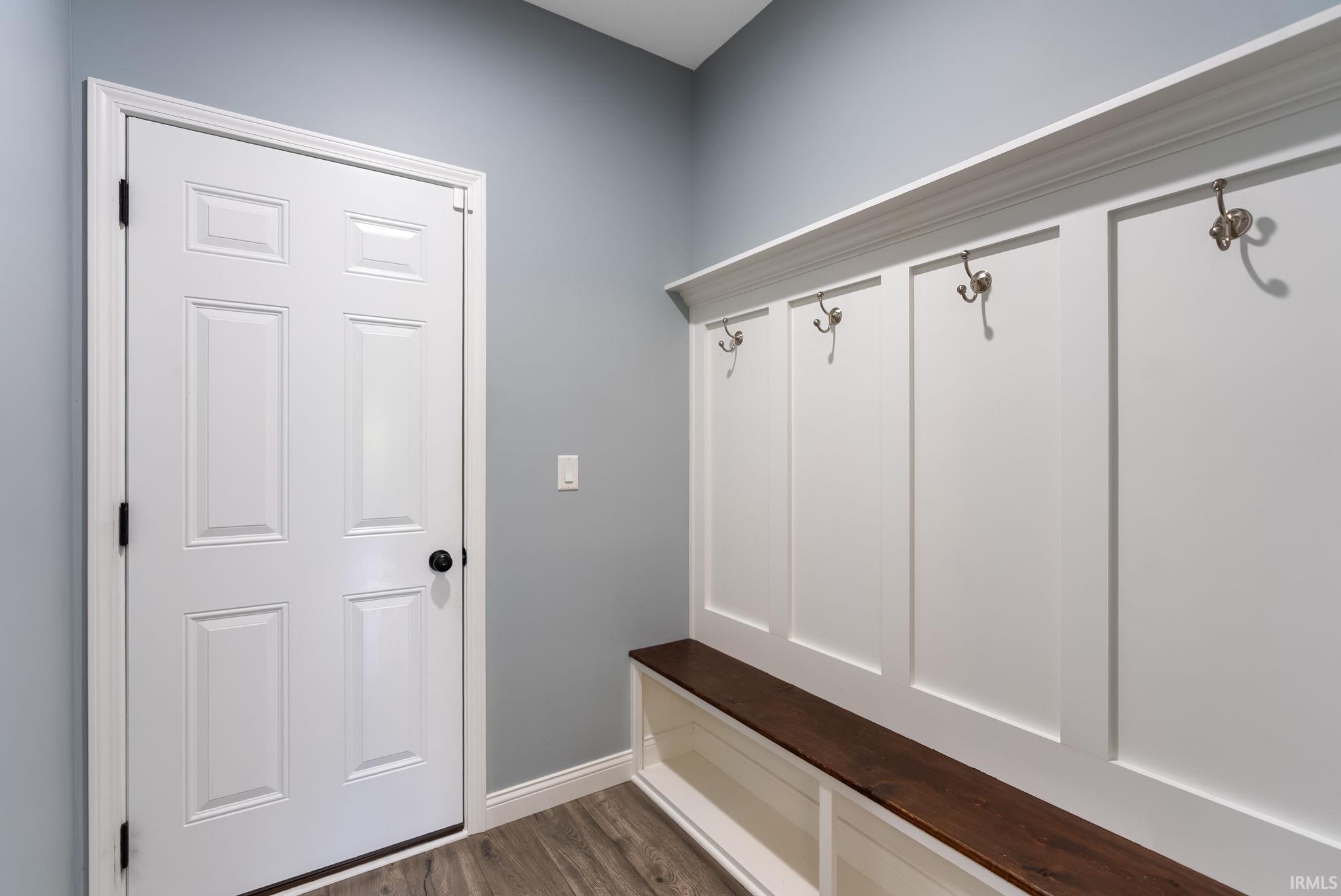 Built-in mudroom bench with wood-finish top and integrated storage