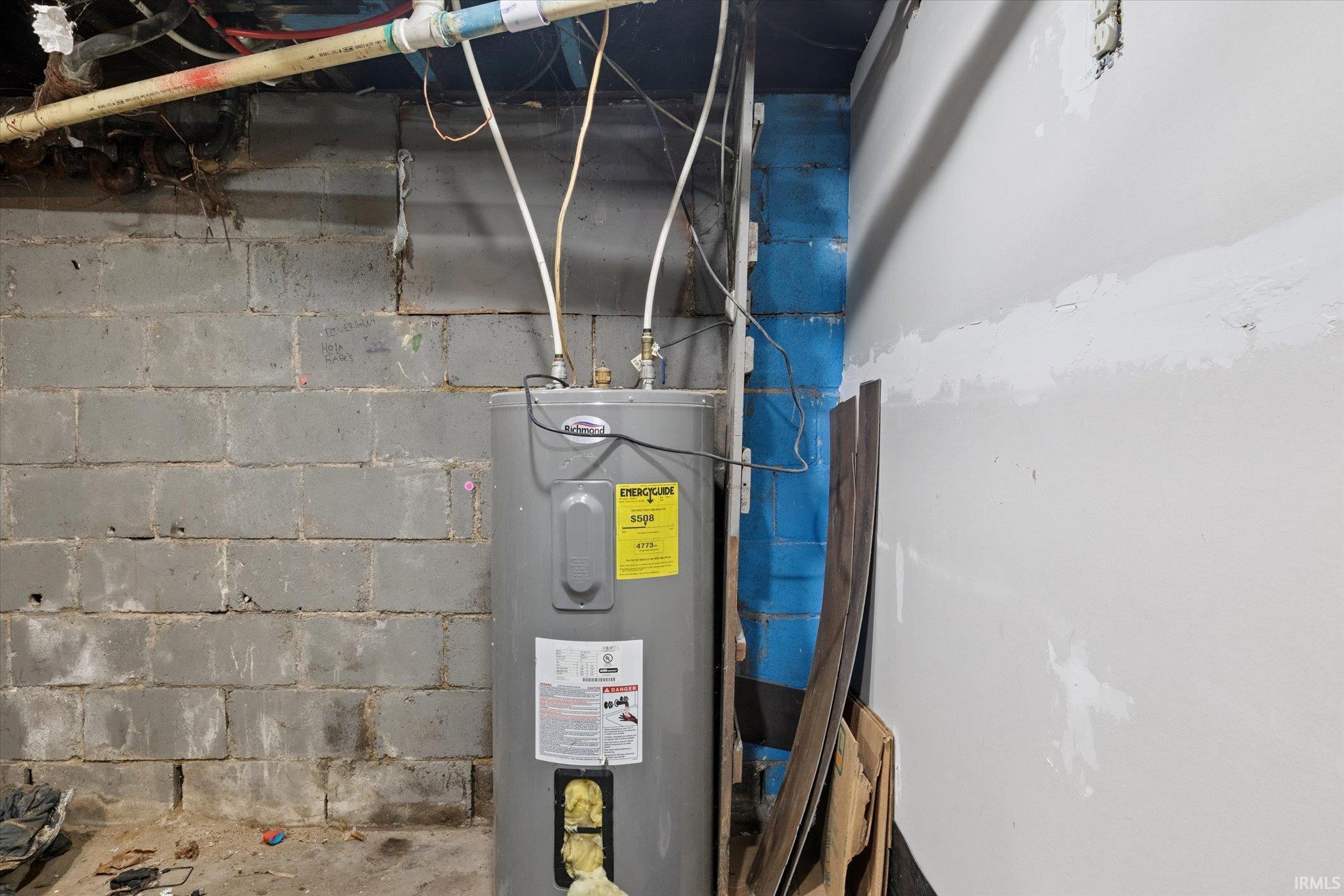 Hot water heater installation with visible plumbing lines