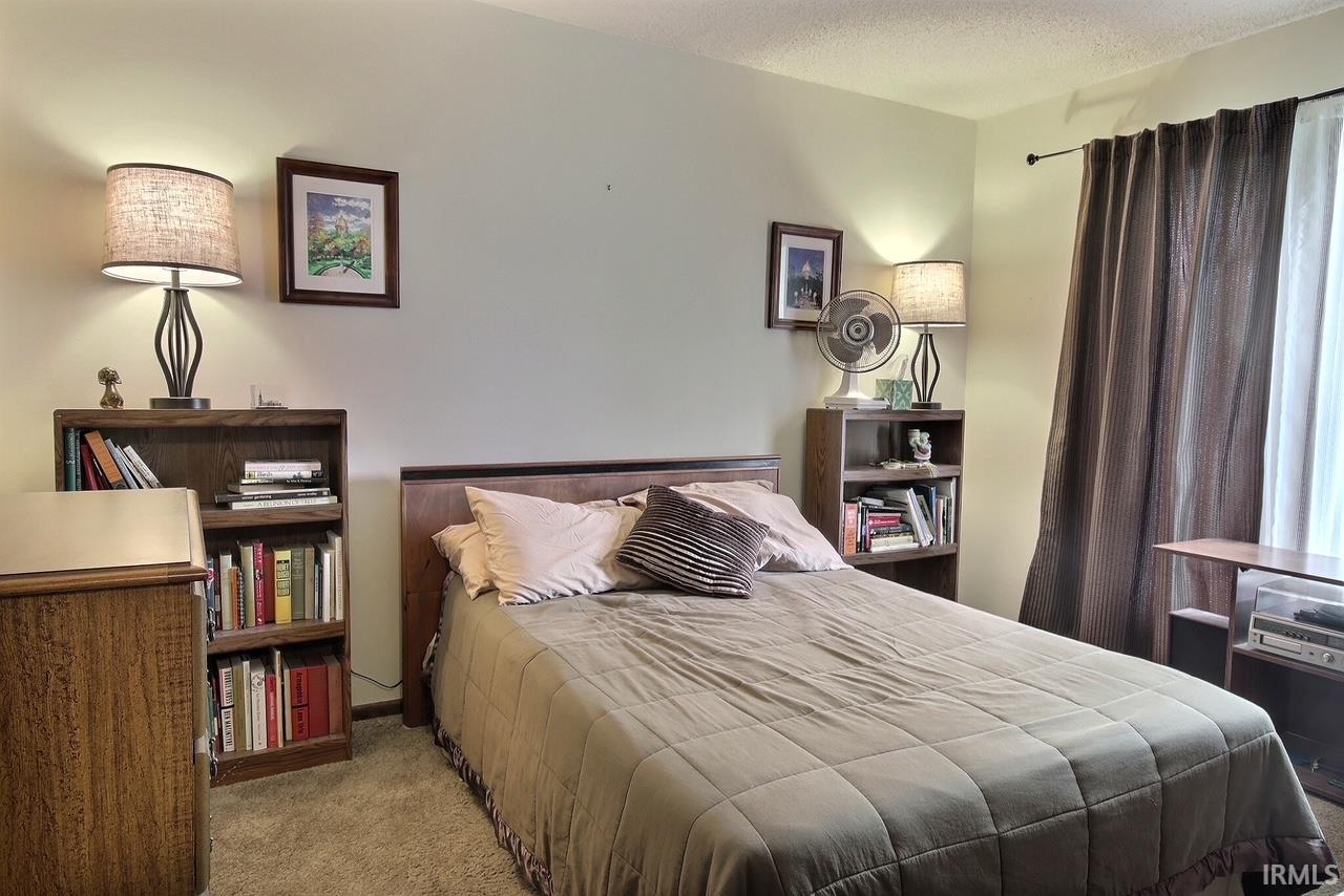 Neutral-toned walls complement plush carpeting