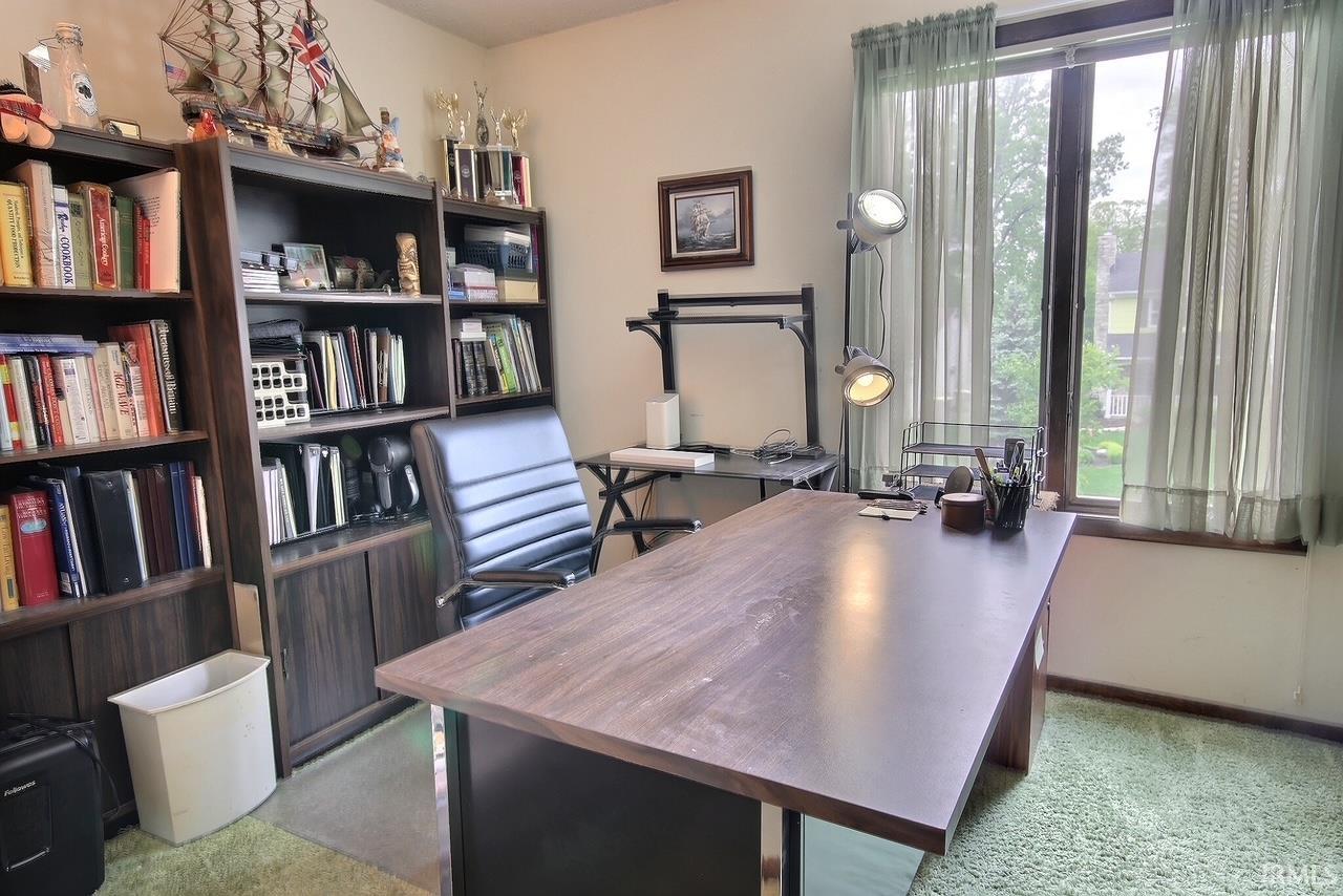 Dedicated room featuring a large window with sheer curtains