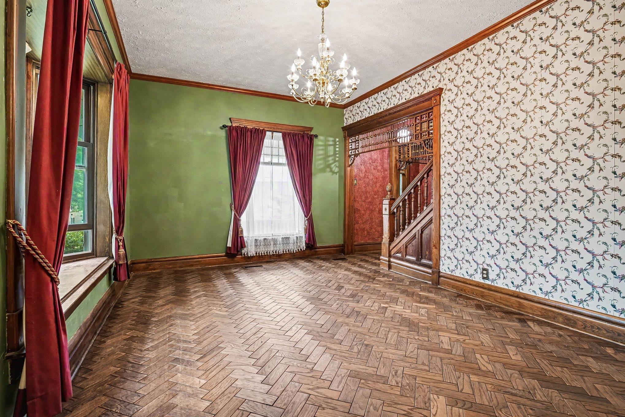 Herringbone wood-finish flooring complements the room's rich wood trim