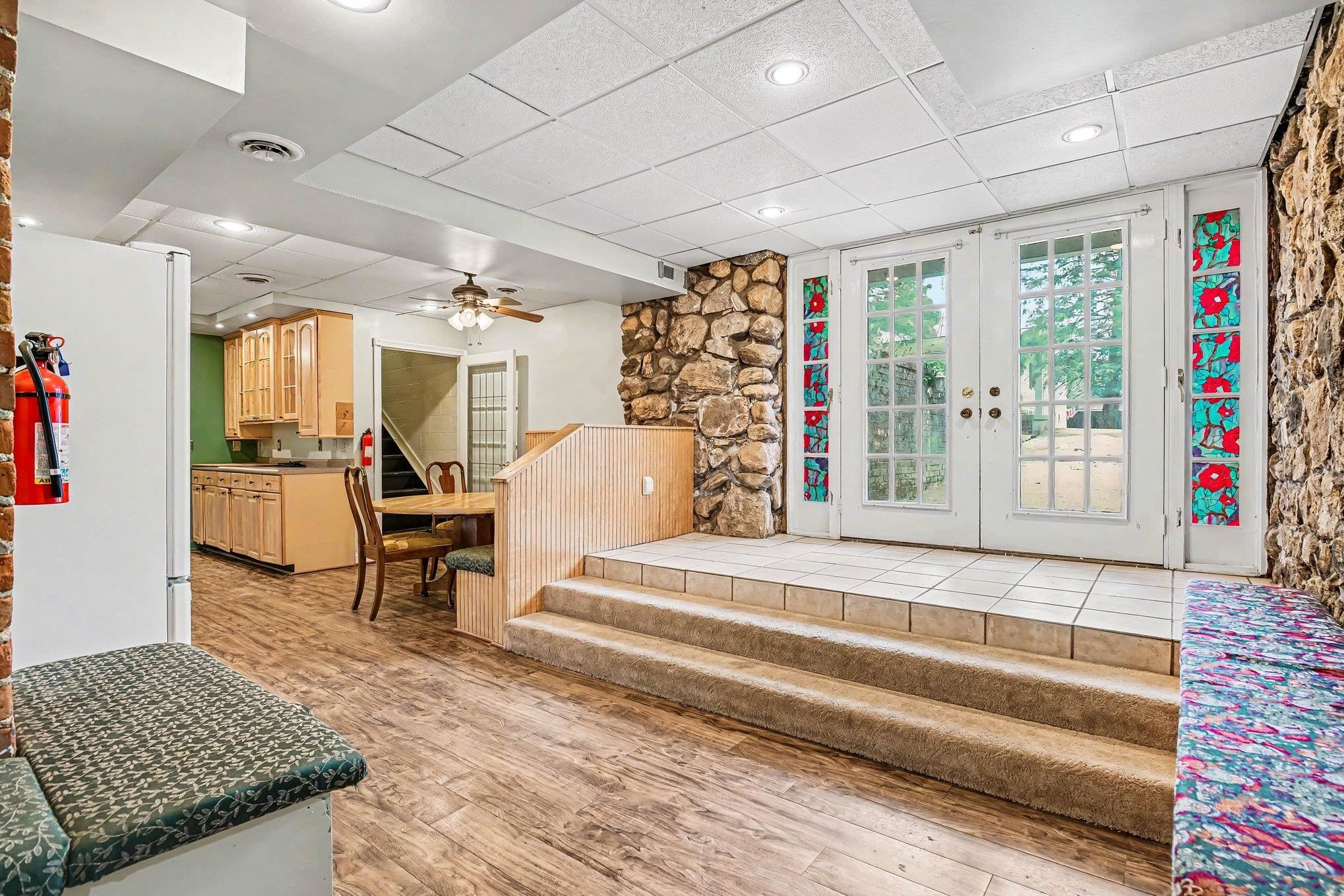 Garden level entry with French doors and transom windows