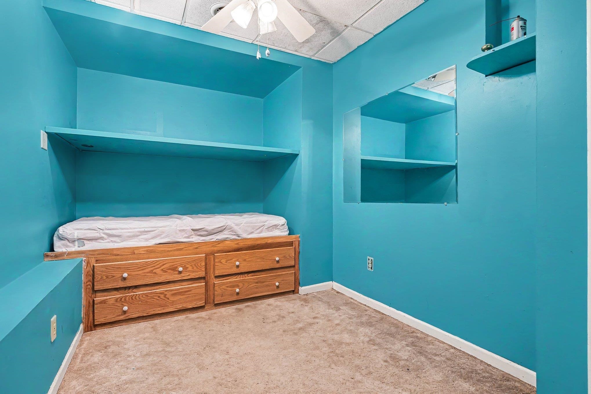 Room with vibrant blue walls and built-in features