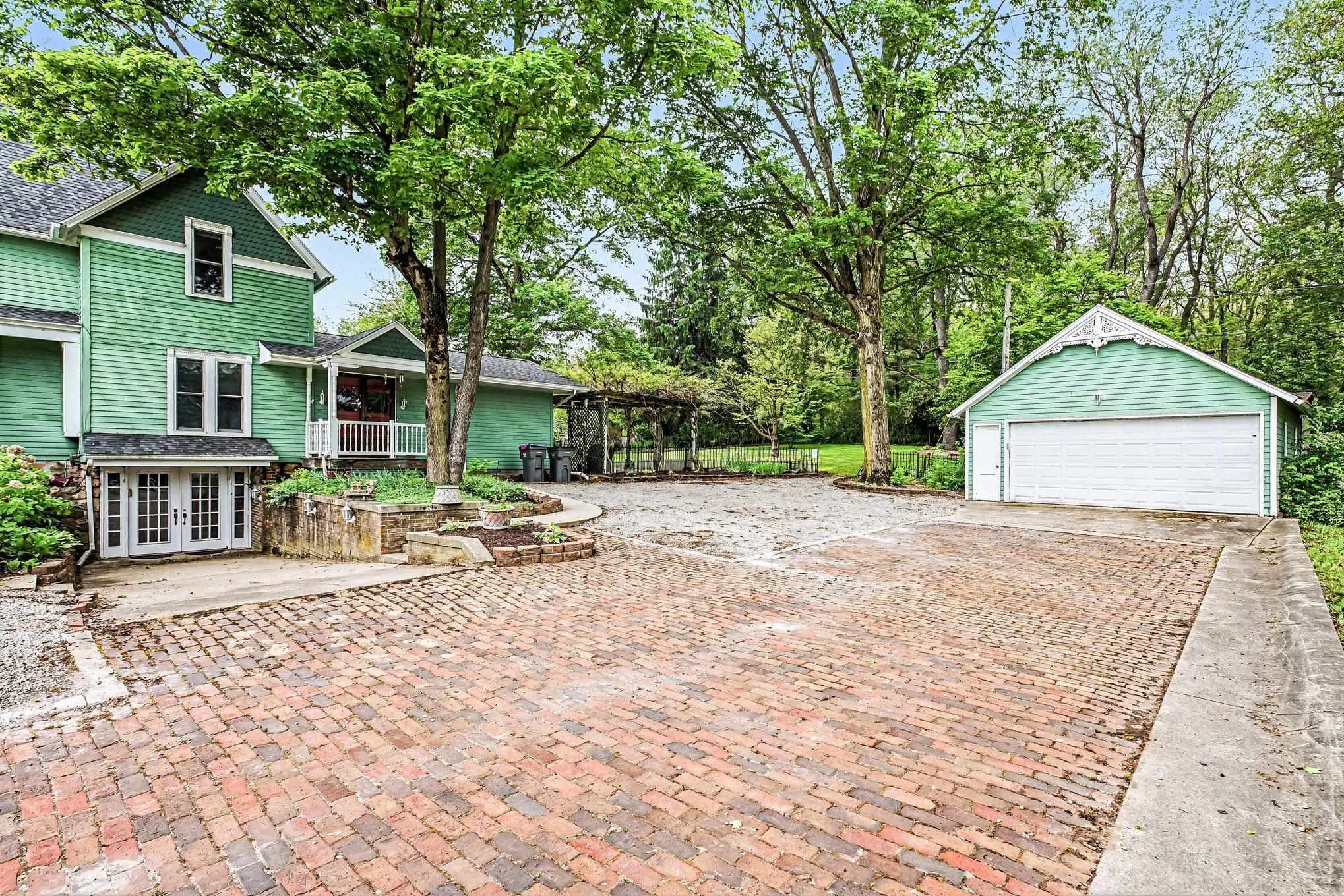 Expansive brick paver driveway offering ample parking