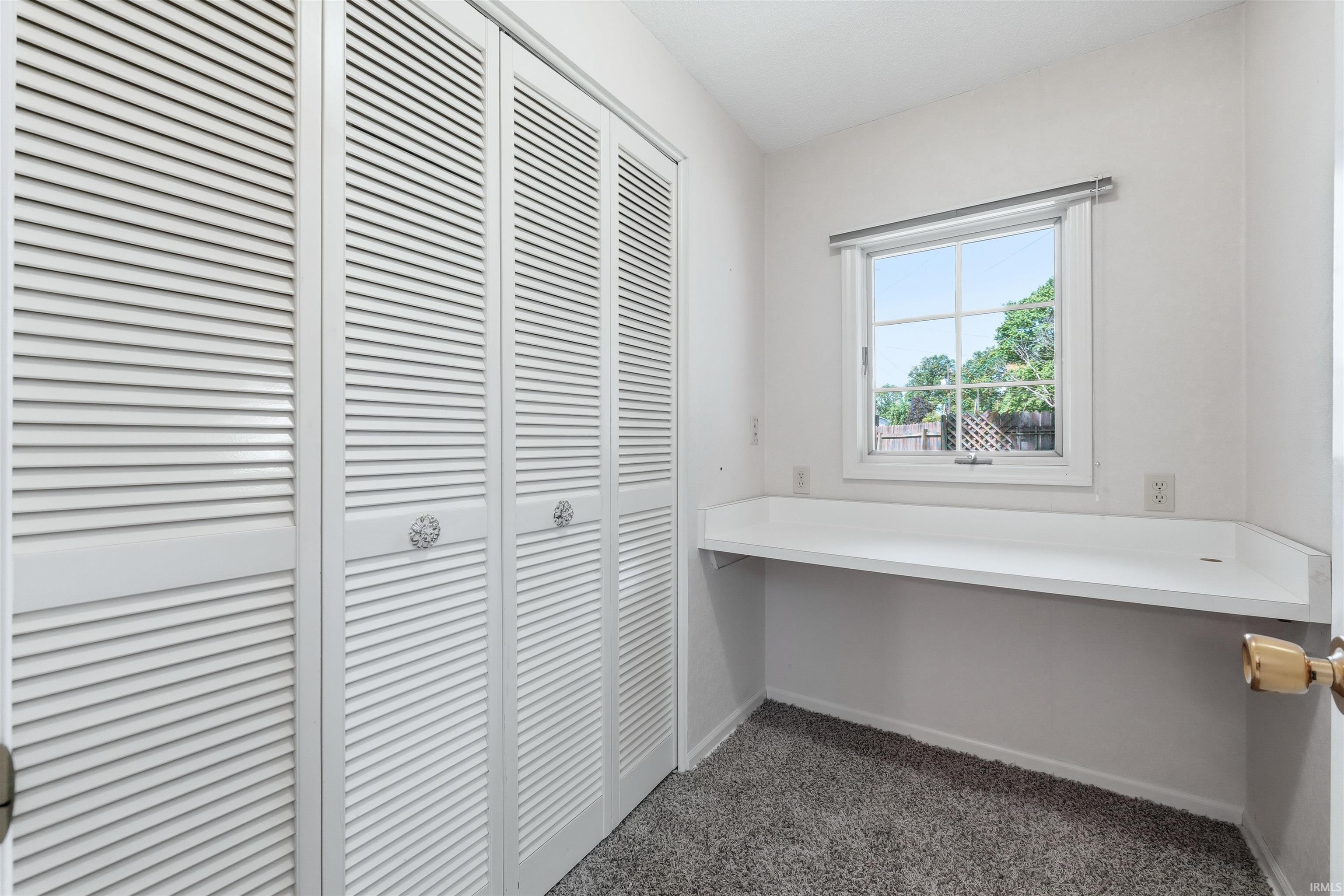 Built-in desk surface positioned below a window with a natural light exposure