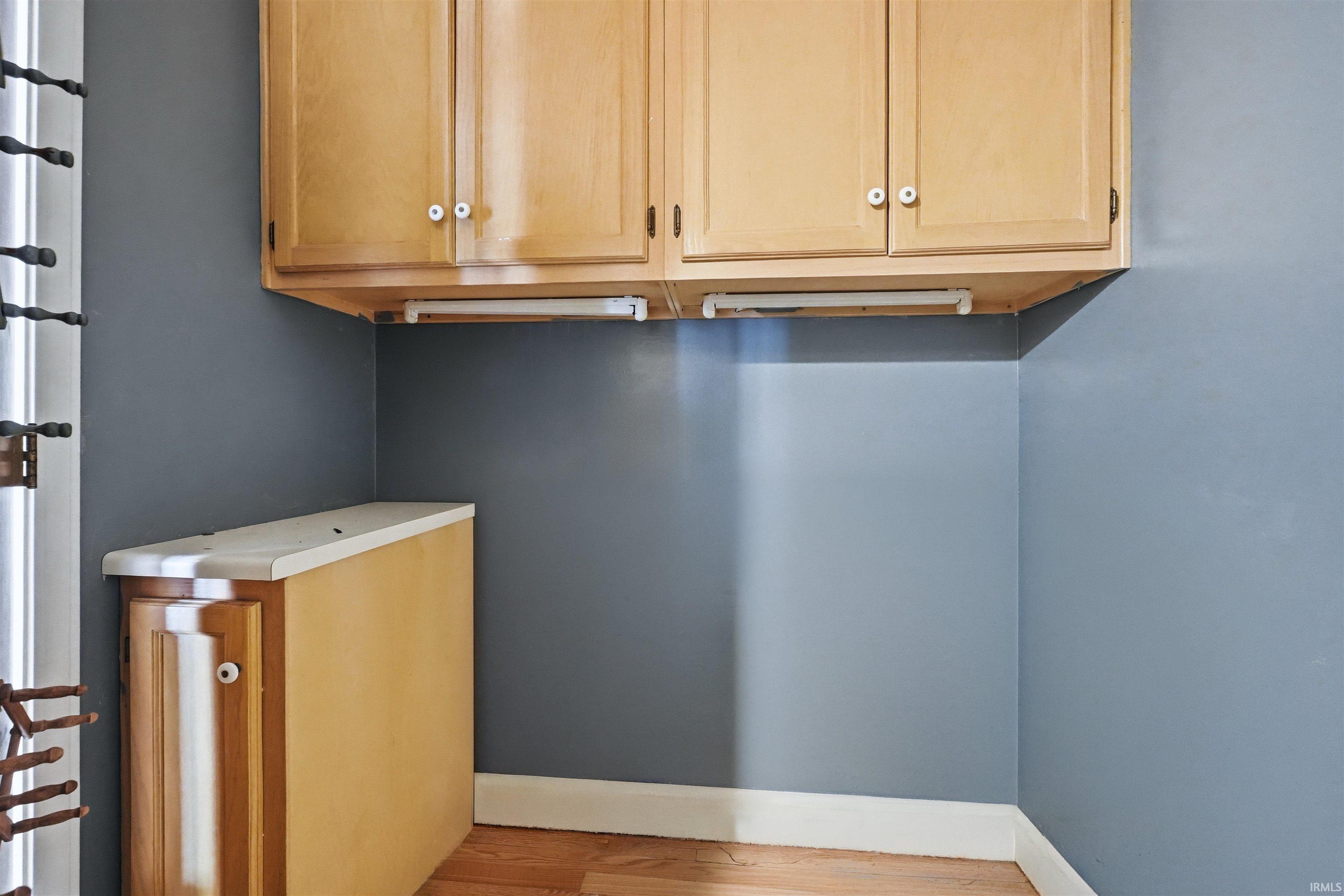 Upper cabinetry with light wood-finish doors and white knobs