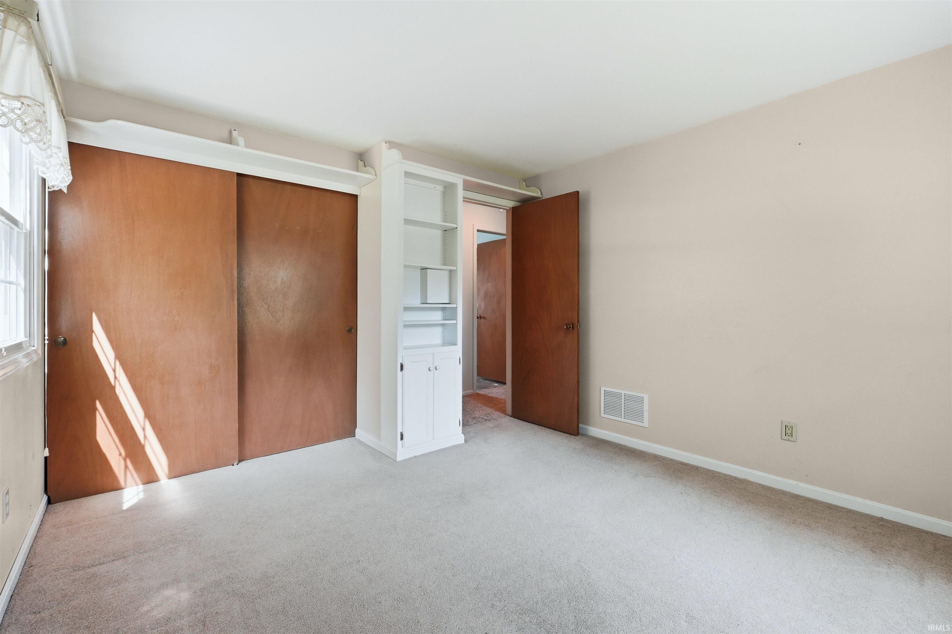 Neutral wall color and light gray carpeting create a versatile interior