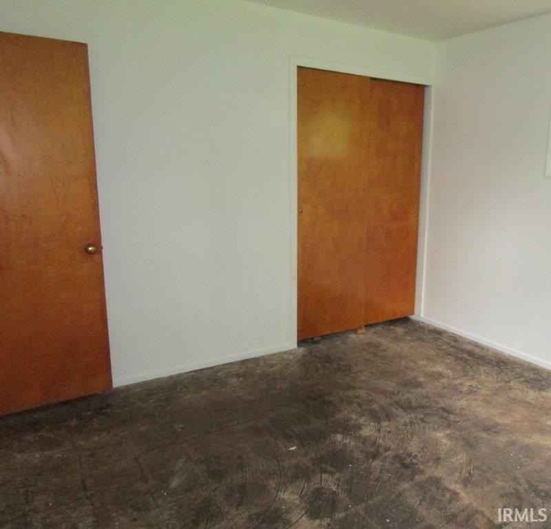 Wood-tone doors contrasting with white walls and trim, featuring a sliding closet door
