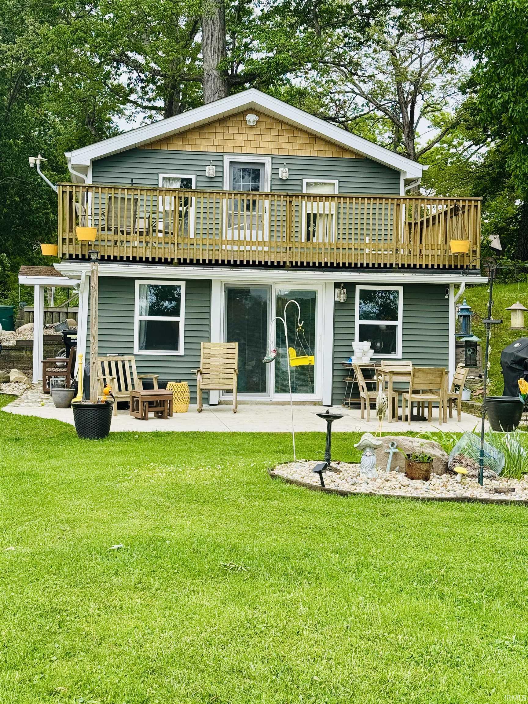 Two-story exterior with green siding and a wood shake gable accent