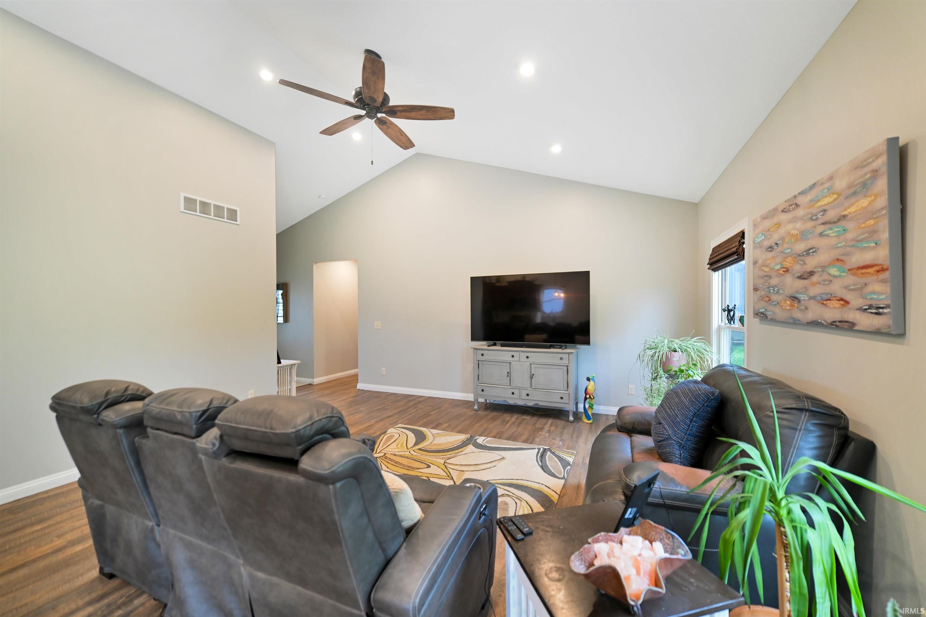 Vaulted ceilings featuring recessed lighting and a ceiling fan