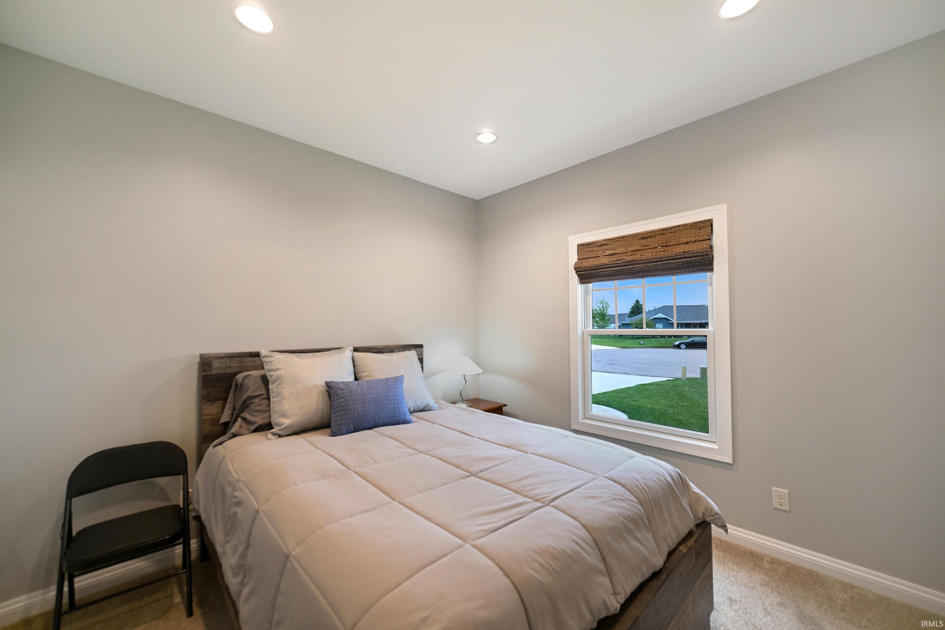 Carpeted room with neutral wall paint and recessed ceiling lighting