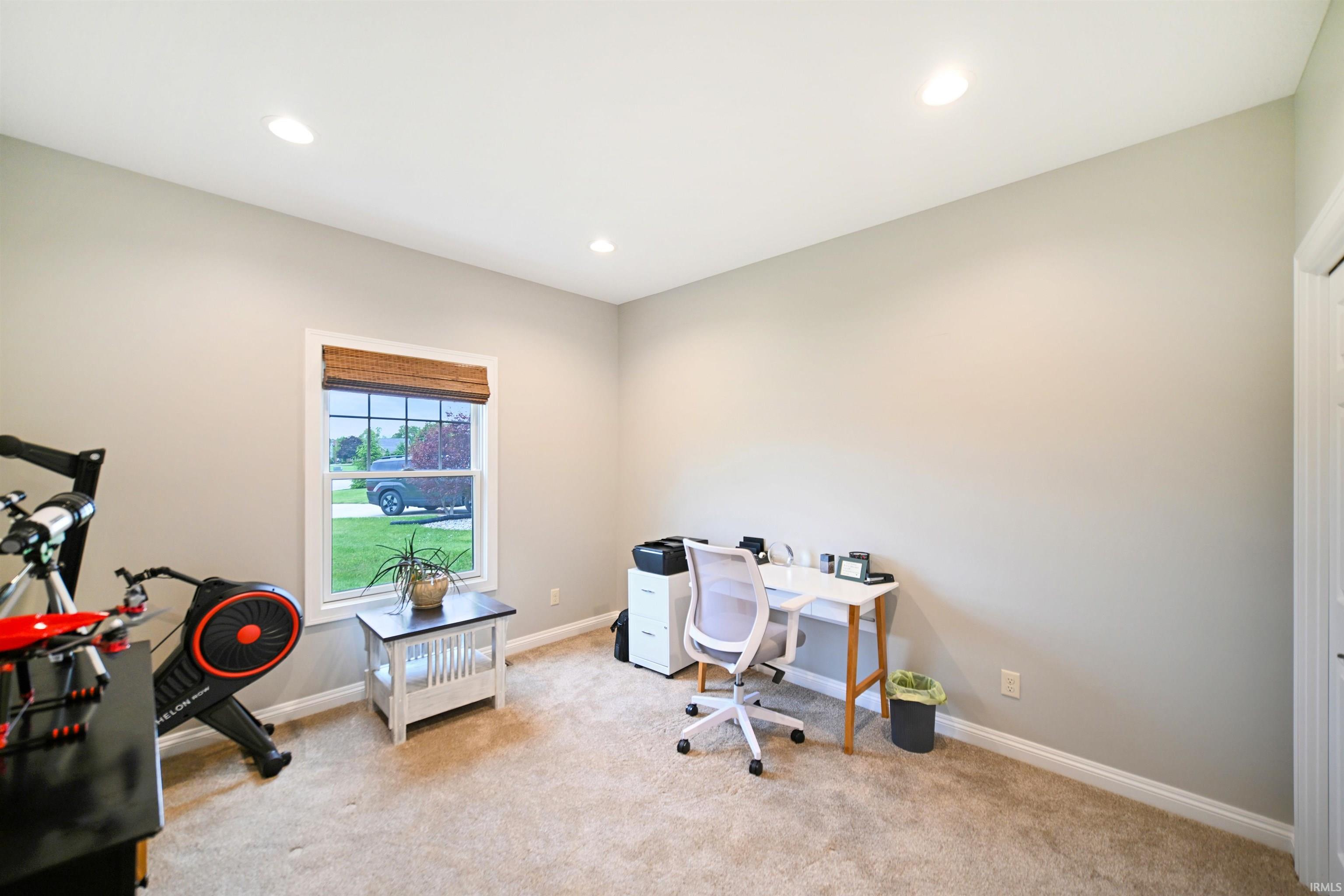 Carpeted room with recessed lighting, light gray wall paint, and white trim
