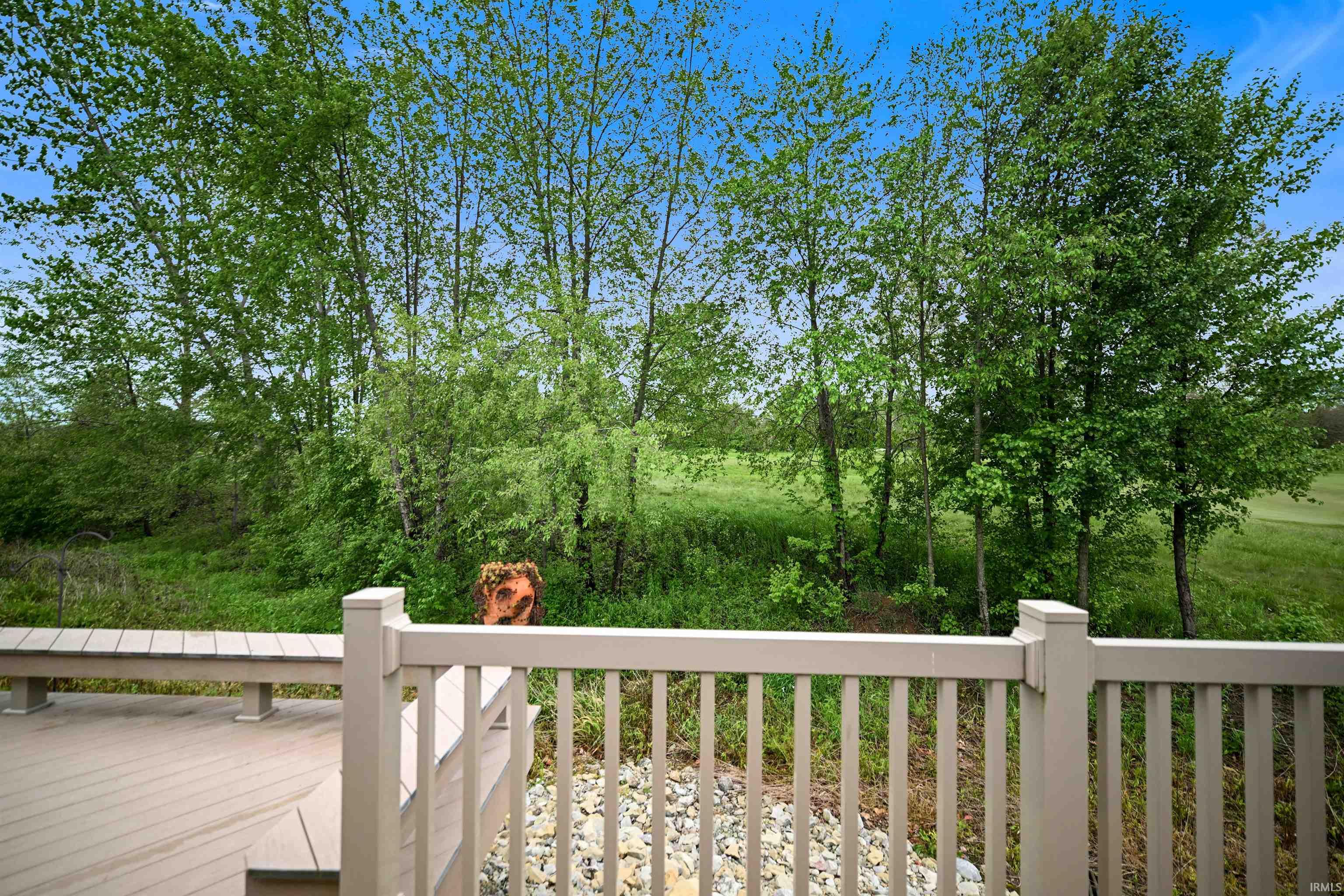 Expansive outdoor deck featuring composite decking, integrated bench seating, and a white railing system