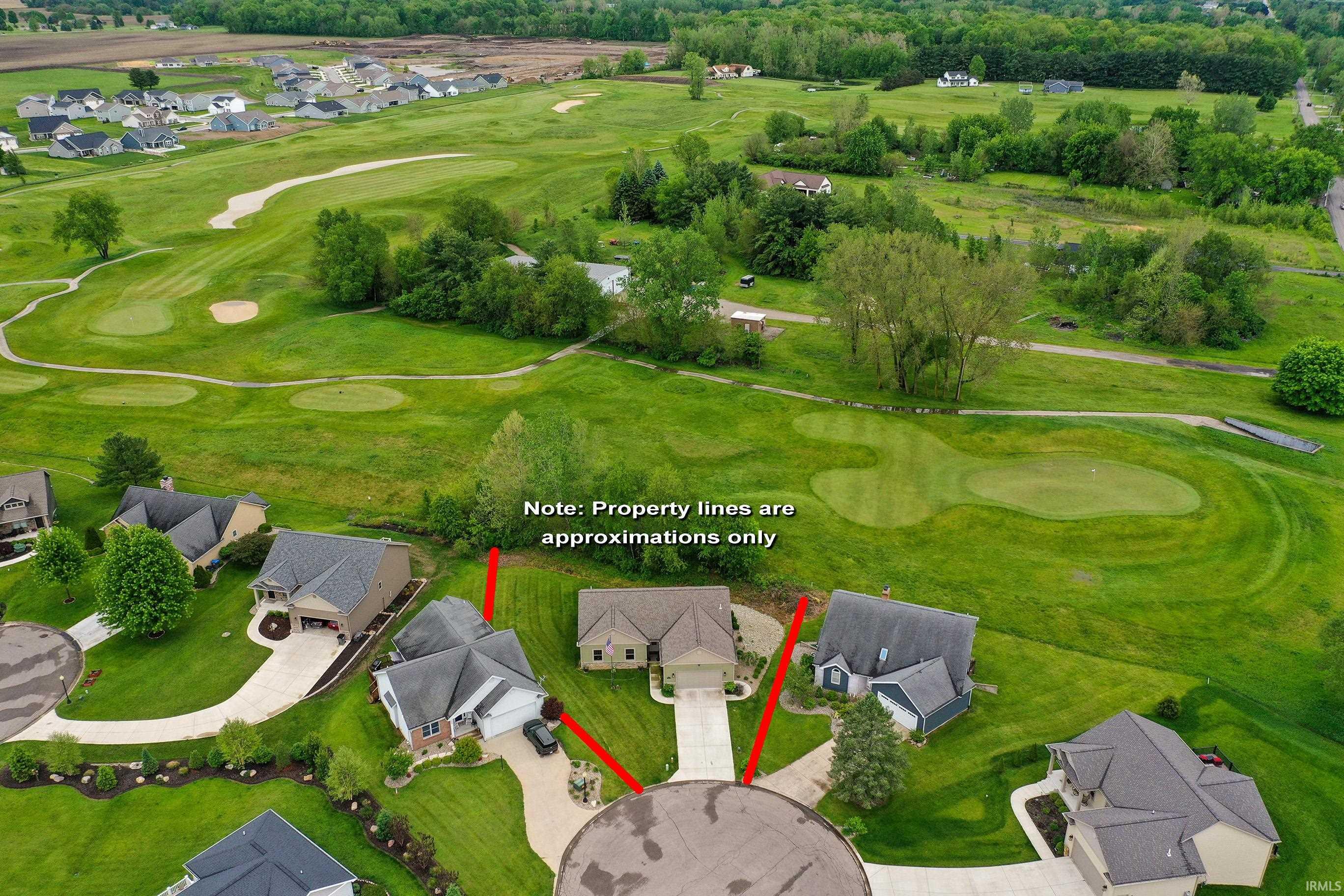 Aerial perspective showcasing a residential property situated at the end of a cul-de-sac