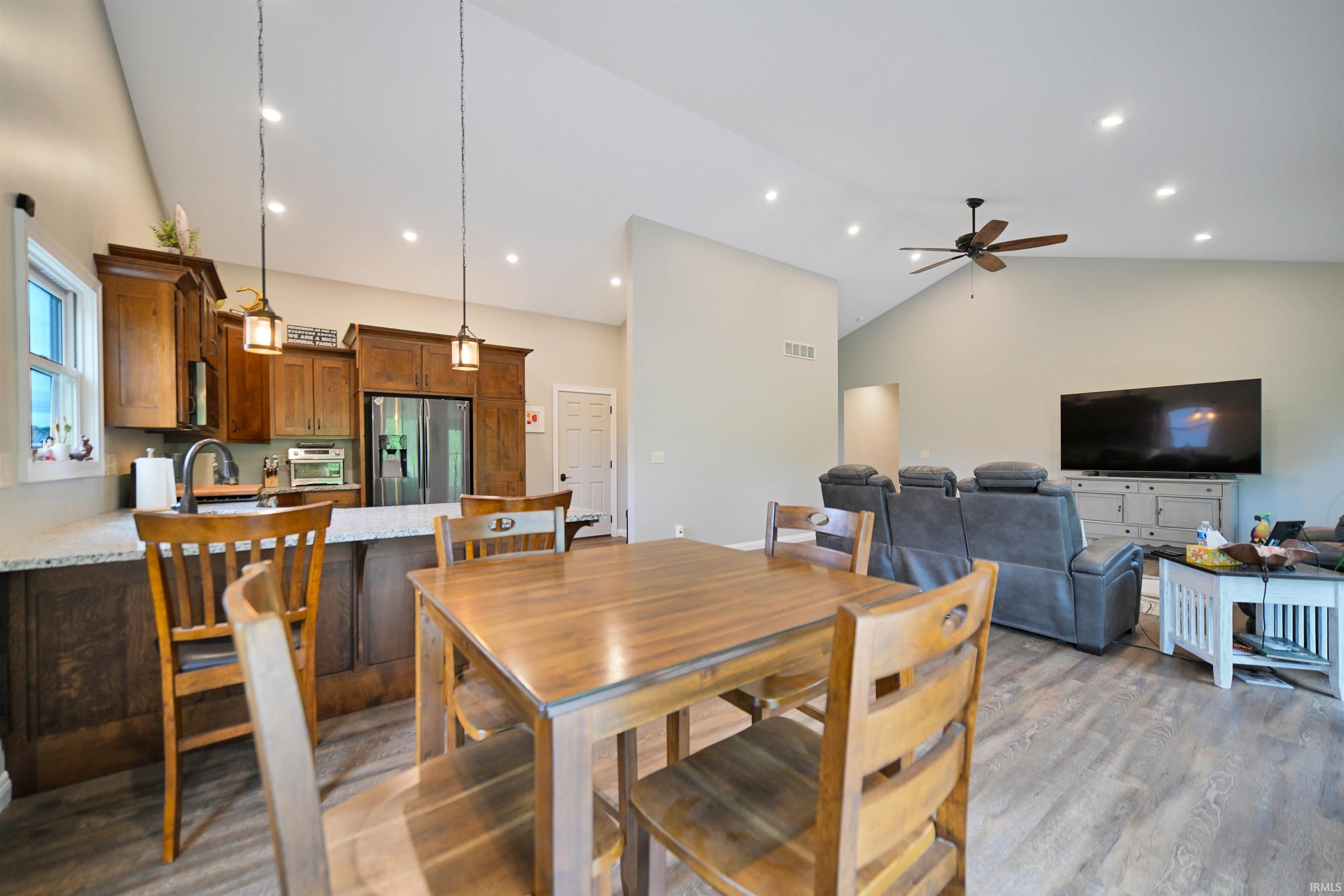 Open-concept living space featuring vaulted ceilings and recessed lighting