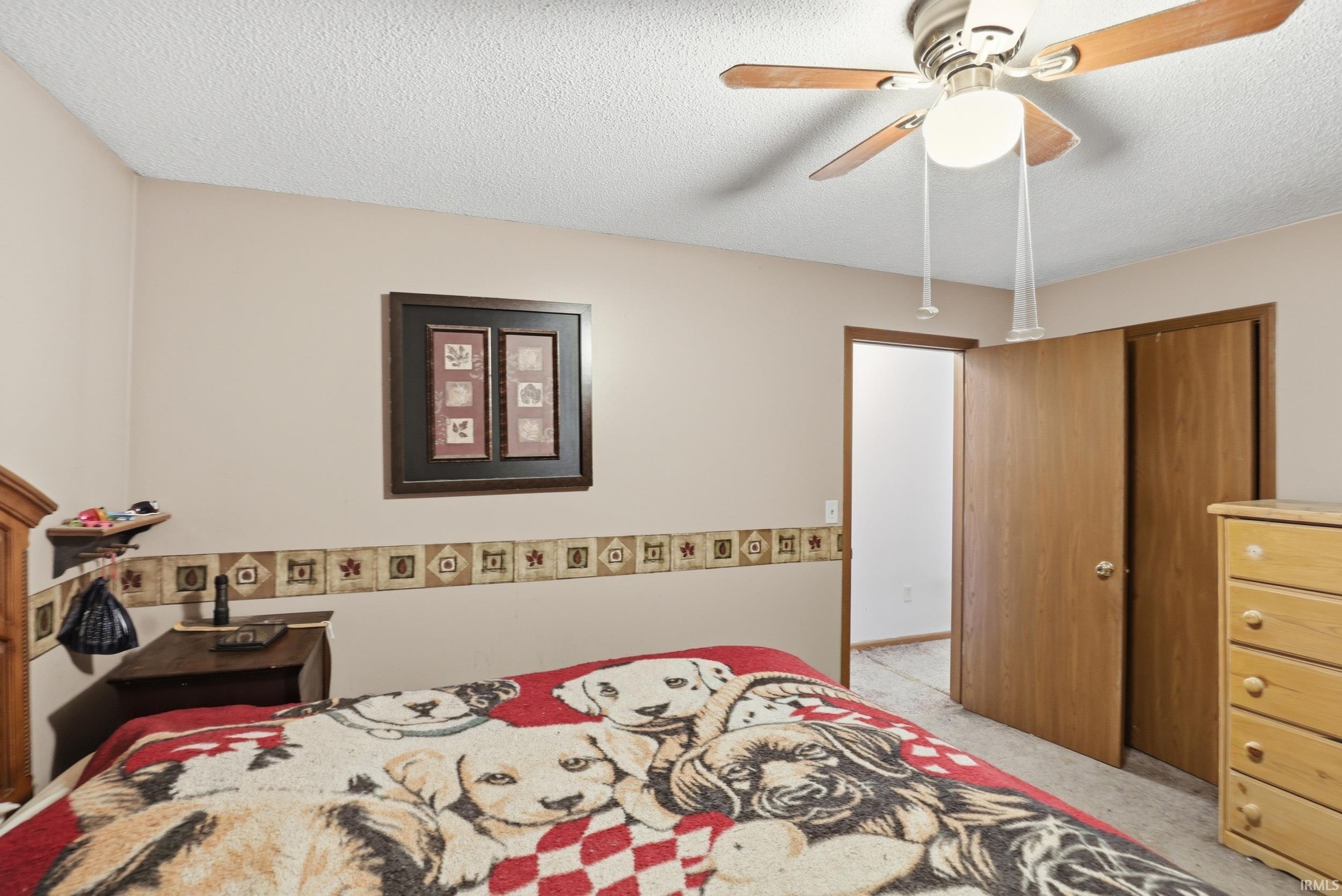 Recessed ceiling with an overhead light fixture and ceiling fan