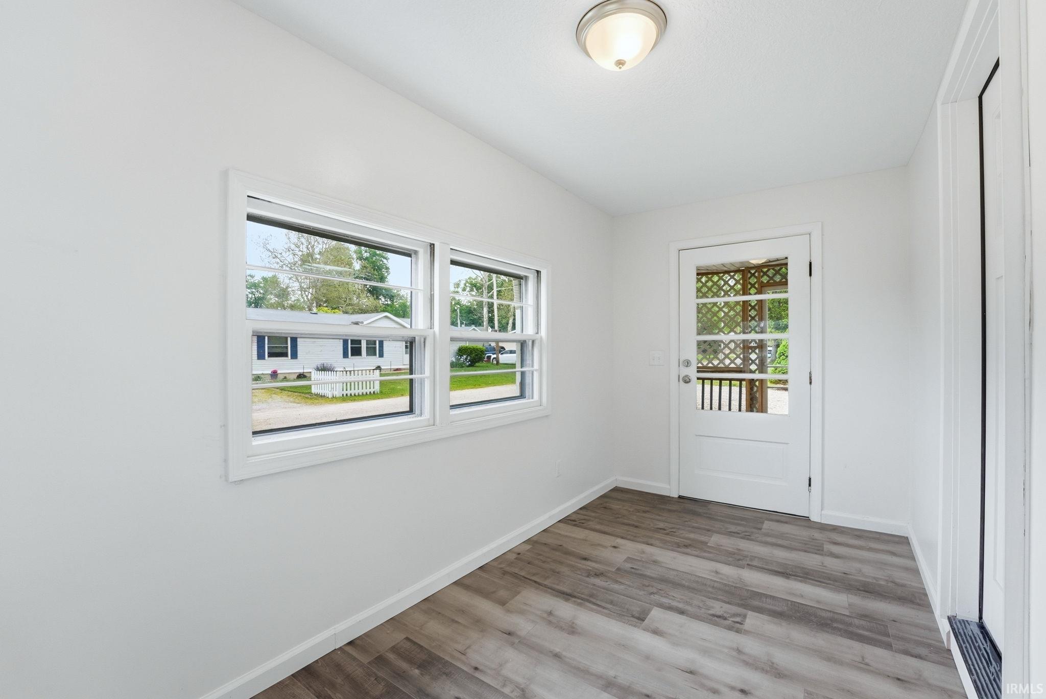 Entryway featuring wood-finish flooring, white walls, and a ceiling-mounted light fixture