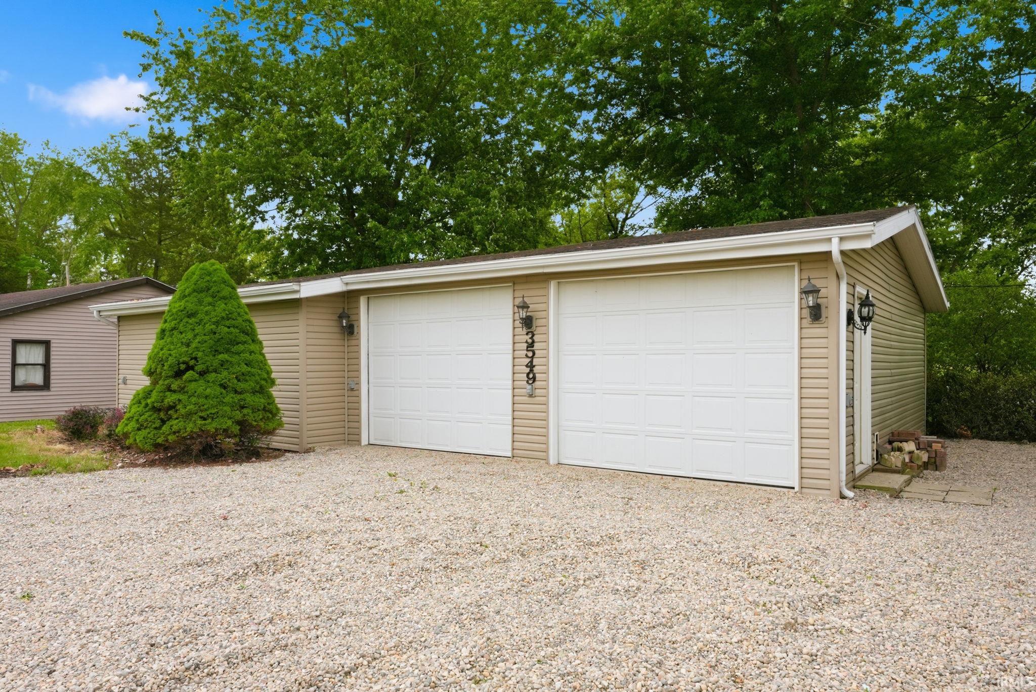 Detached two-car garage with tan horizontal siding