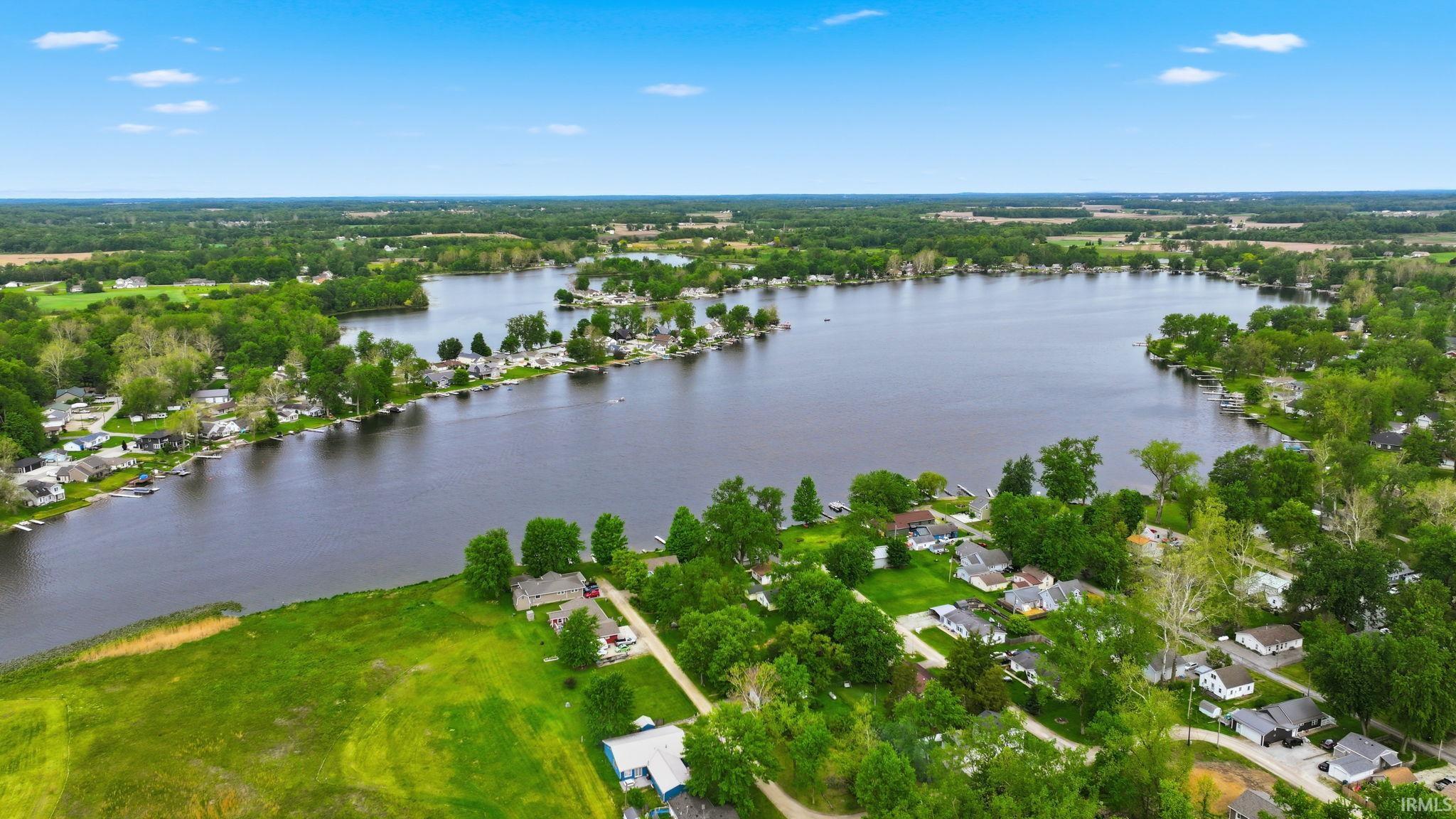 Expansive lakefront setting with numerous properties along the shoreline