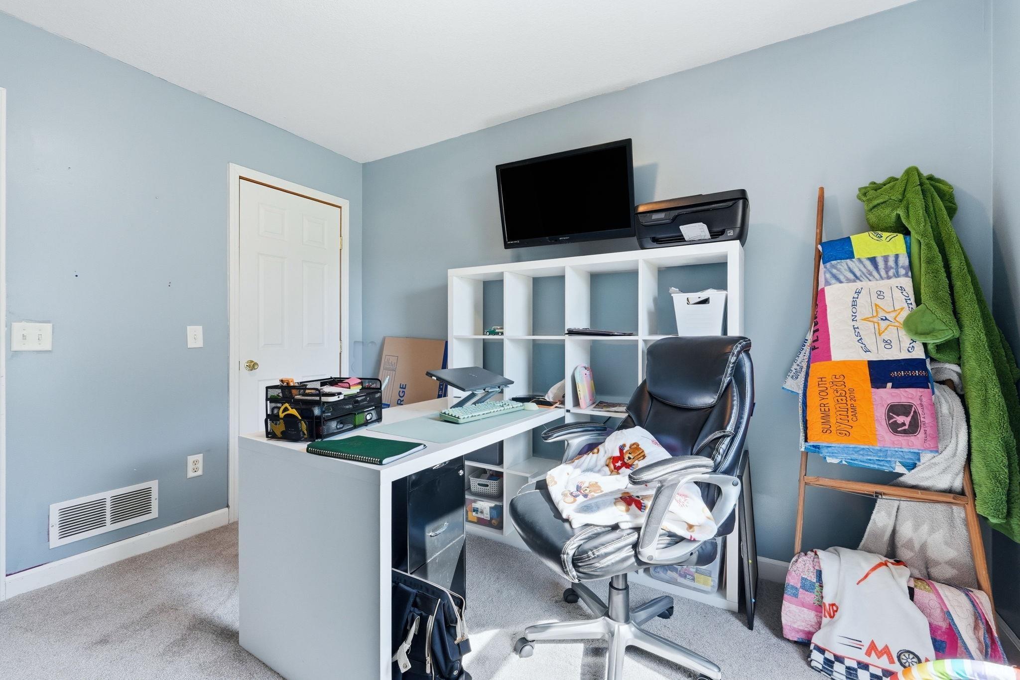 Room featuring light blue wall paint, white trim, and neutral carpet flooring