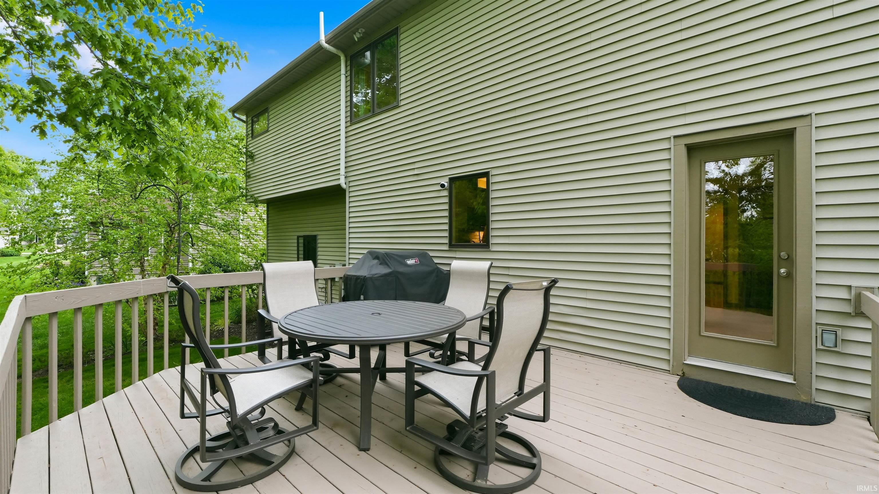 Expansive outdoor deck featuring wood flooring and a perimeter railing