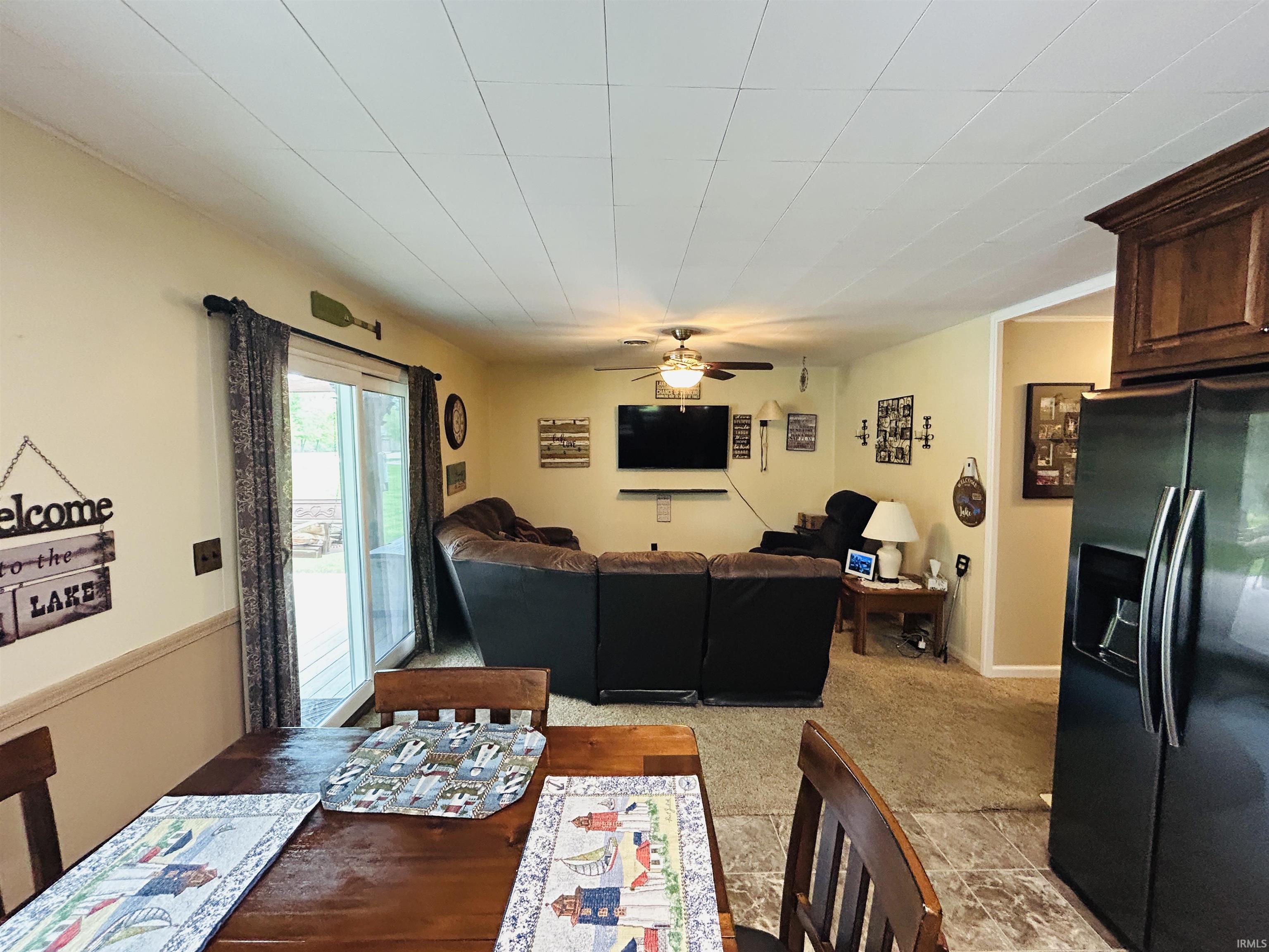 Open concept living and dining area featuring a sliding glass door for outdoor access