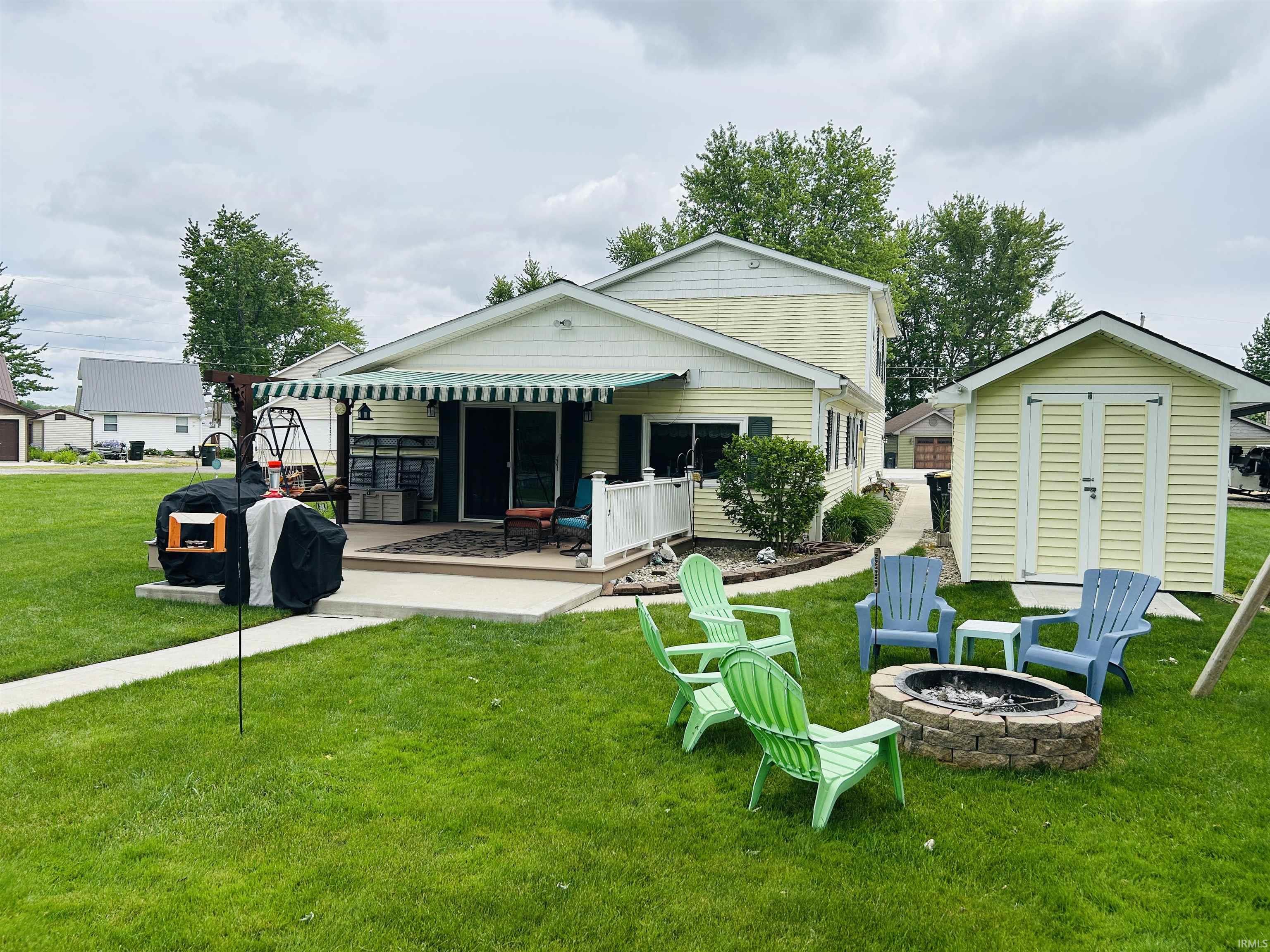 Exterior with light yellow siding and white trim
