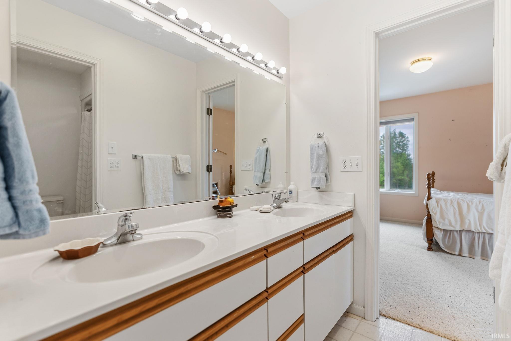 Double vanity with integrated sinks and white countertops
