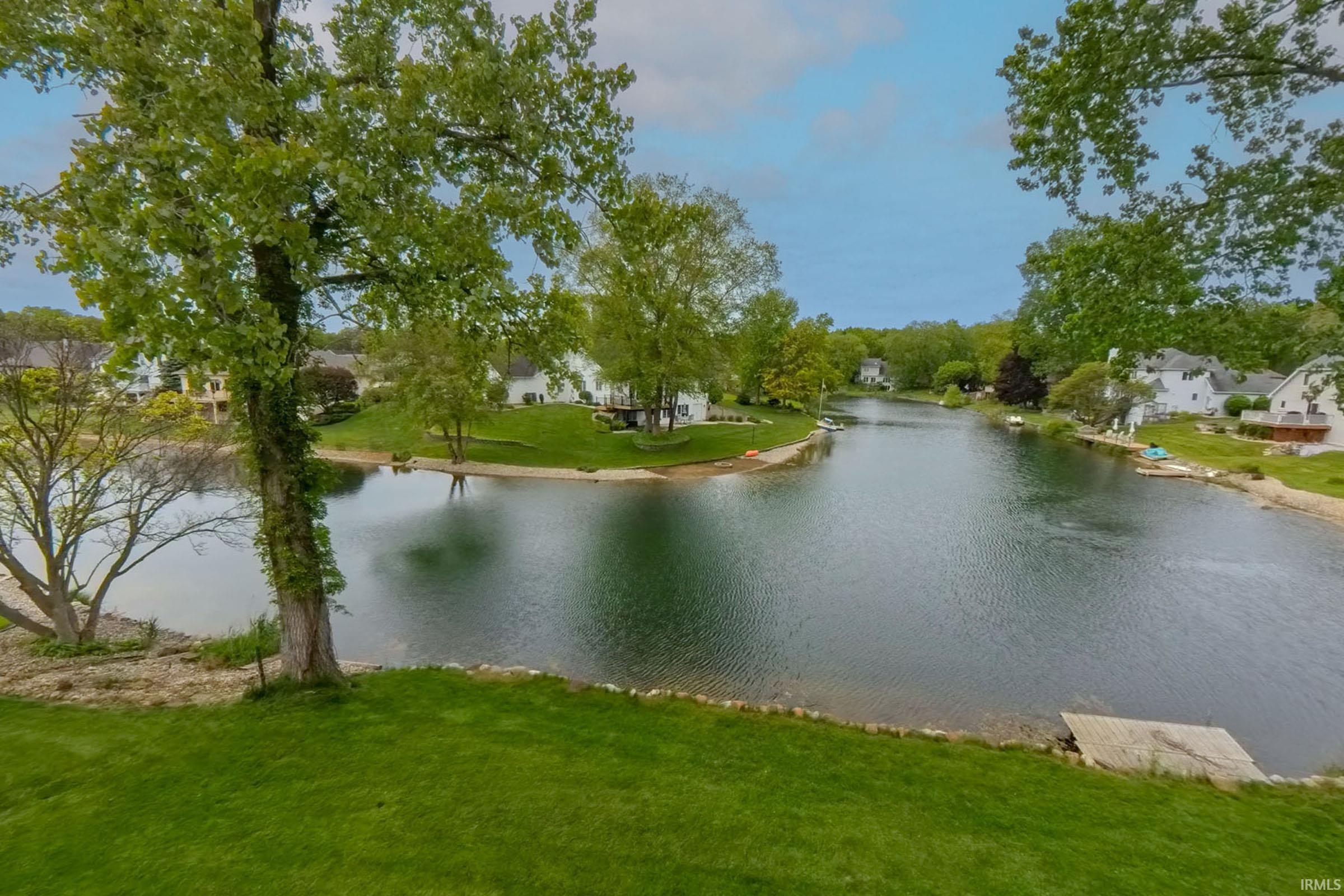 Expansive lakefront property featuring a private dock and direct water access
