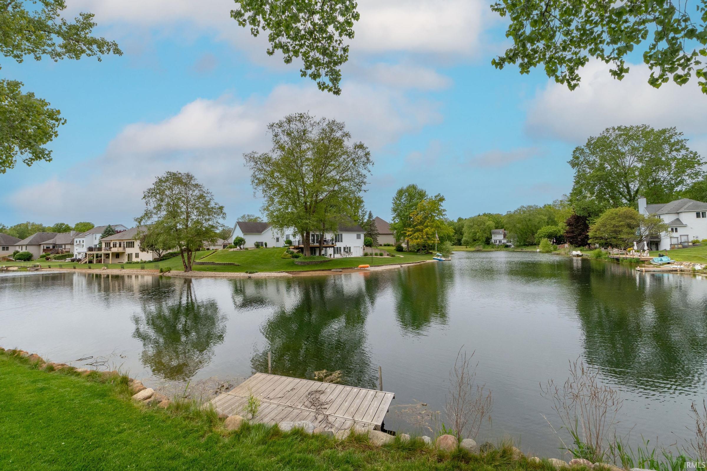Waterfront setting with a wood dock and grassy shoreline