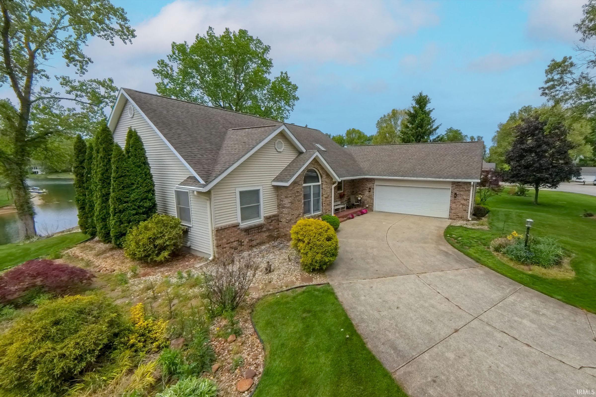 Single-story residence featuring a brick and siding exterior, an attached two-car garage, and a concrete driveway