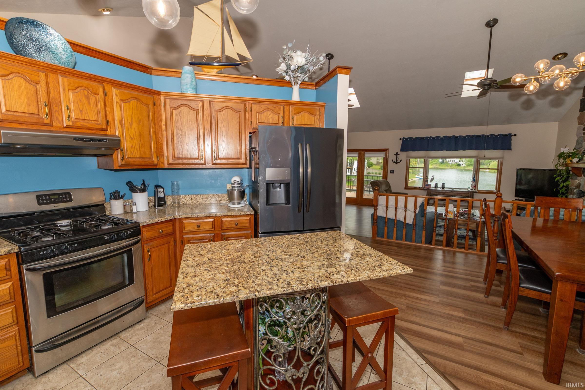Kitchen featuring wood cabinetry, granite-finish countertops, and stainless steel appliances