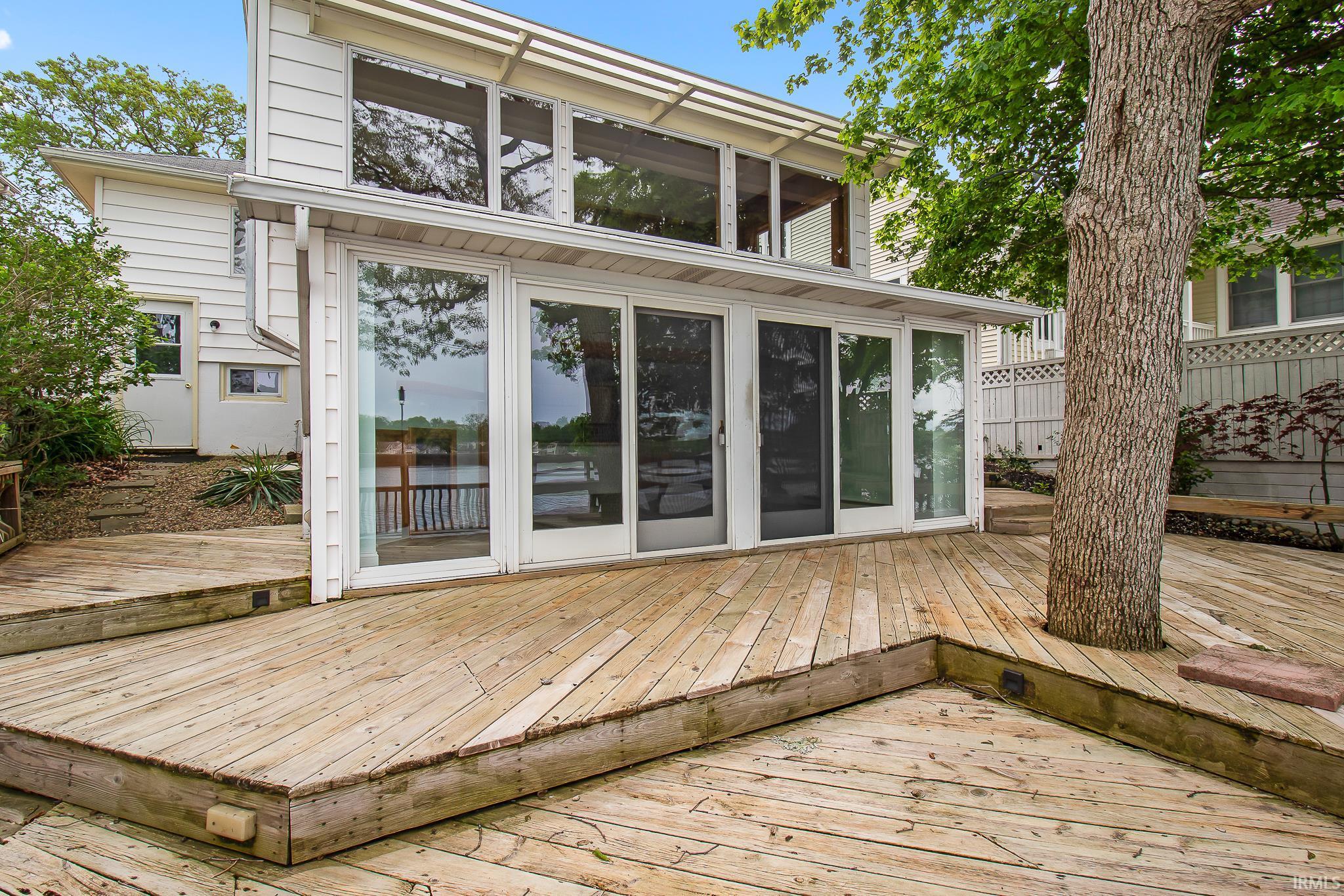 Multi-level wood deck featuring a mature tree integration