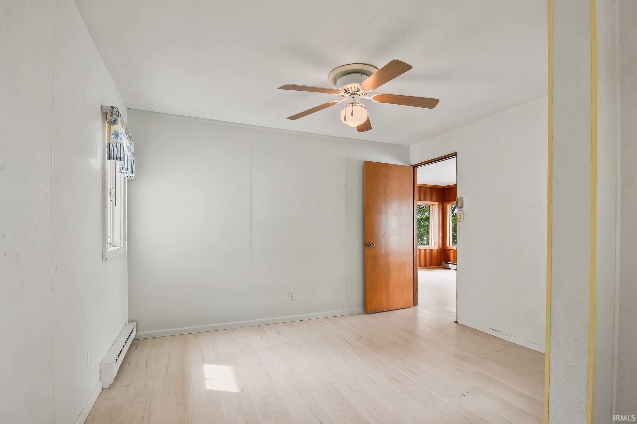Light wood-finish flooring complements the neutral wall color